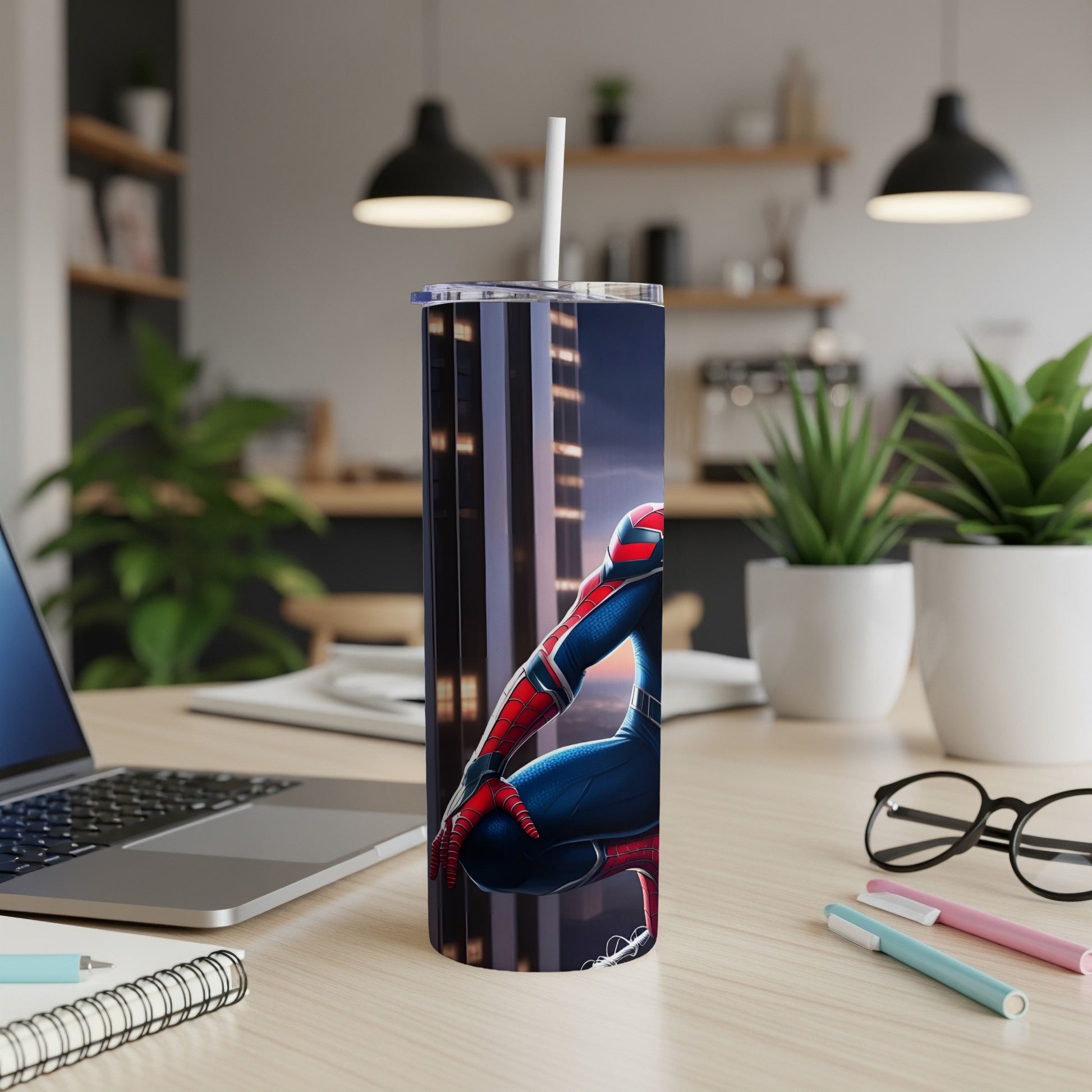 Spiderman character on a tall tumbler with straw, on a desk.