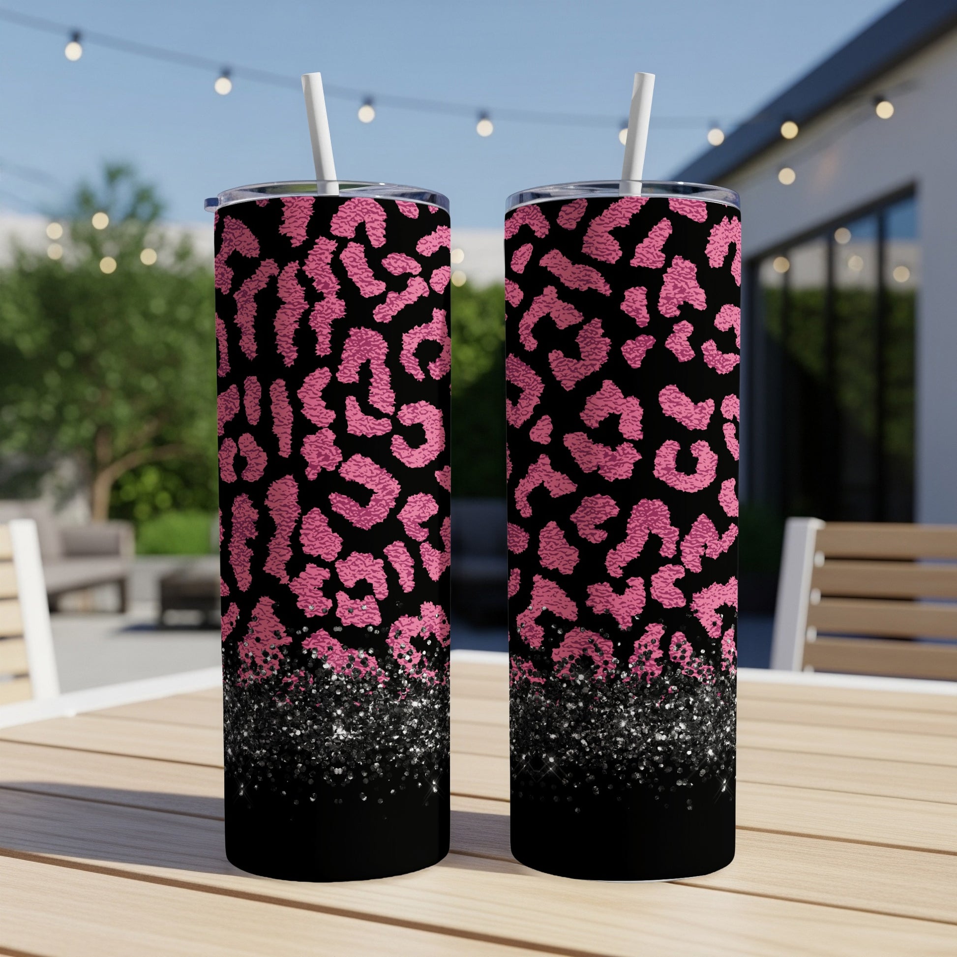 Two tumblers with pink leopard print and glitter.