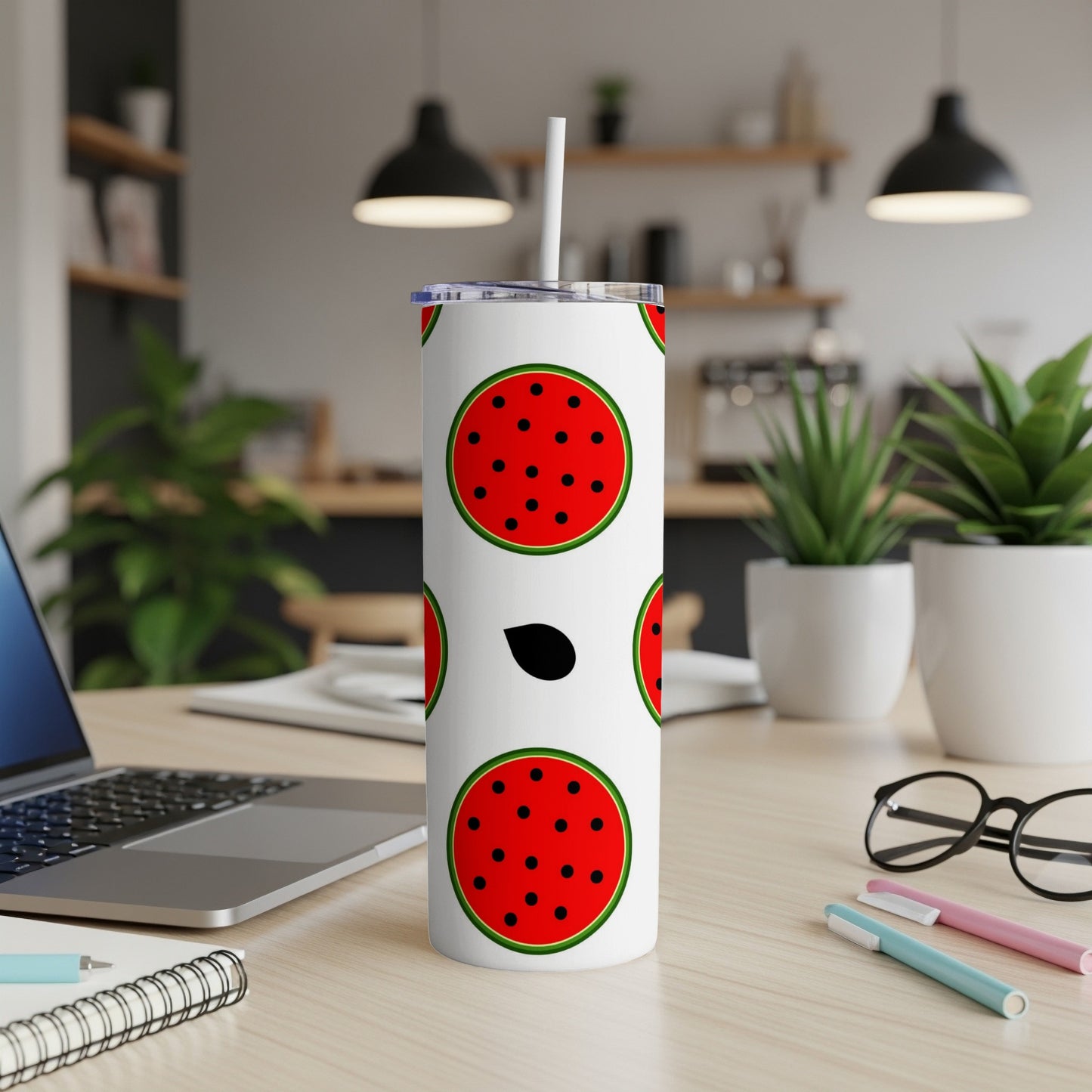 White tumbler with watermelon slices pattern and a straw.