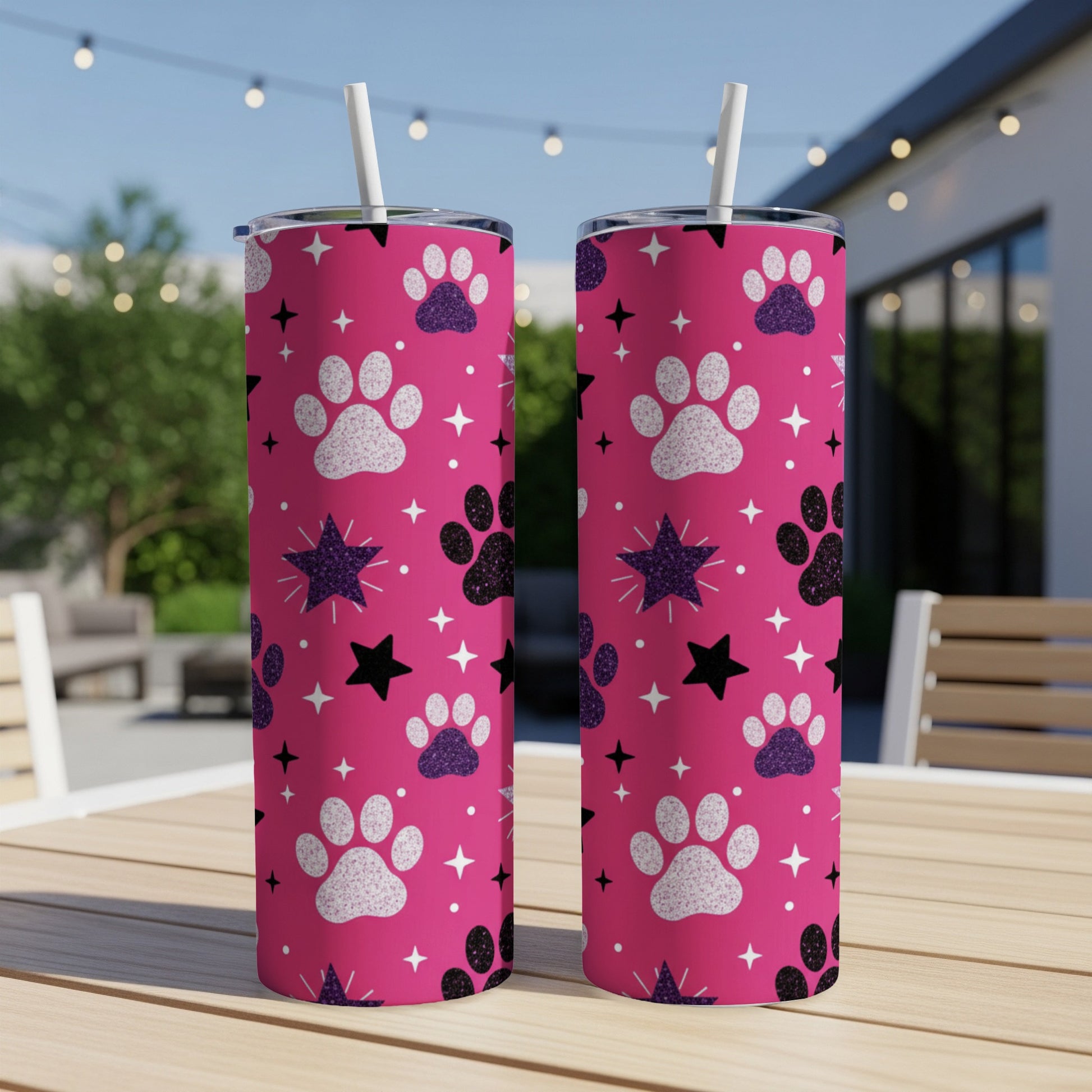 Pink tumbler with paw print and star pattern.