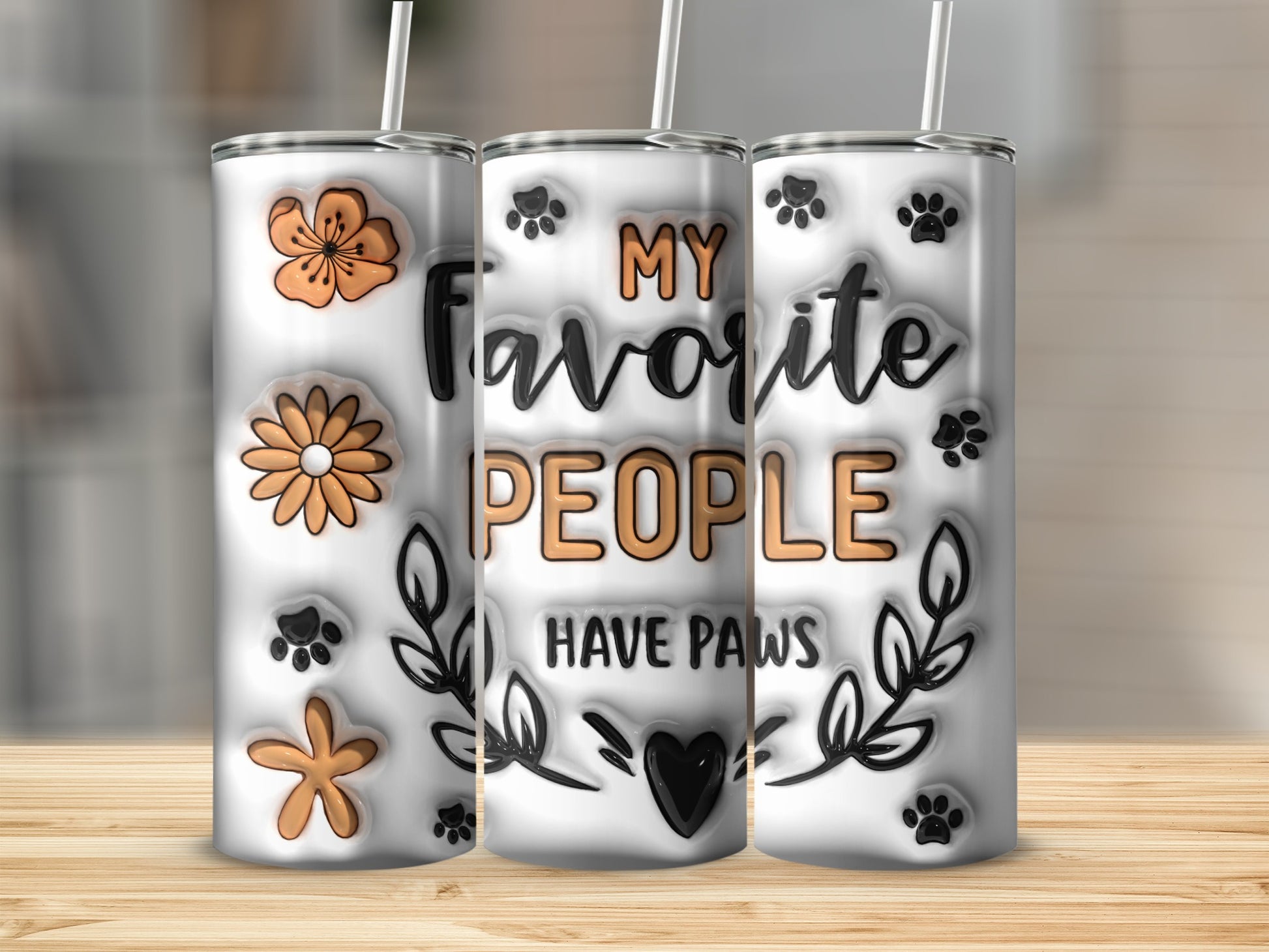 Tumbler with "My favorite people have paws" text, paw prints, and floral designs.