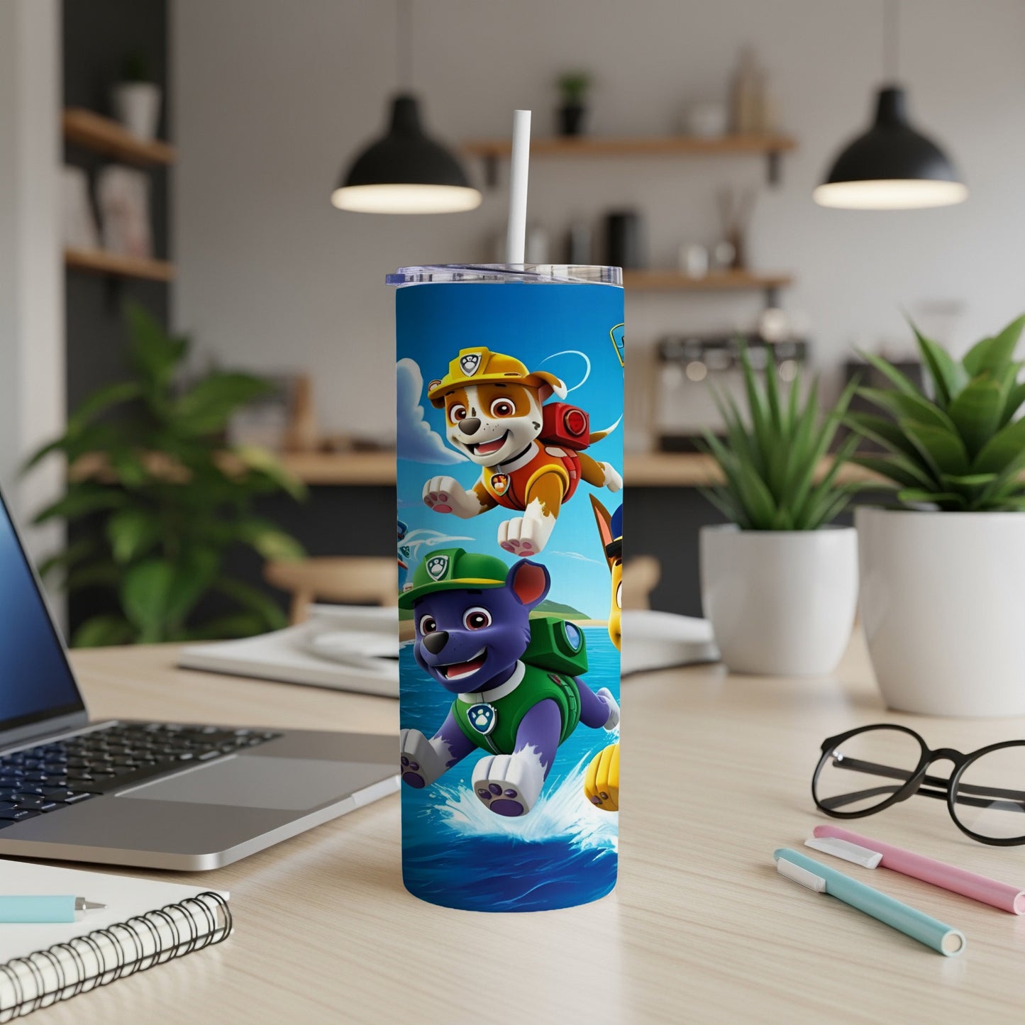 Paw Patrol characters Chase and Marshall on a blue tumbler with water splashes.