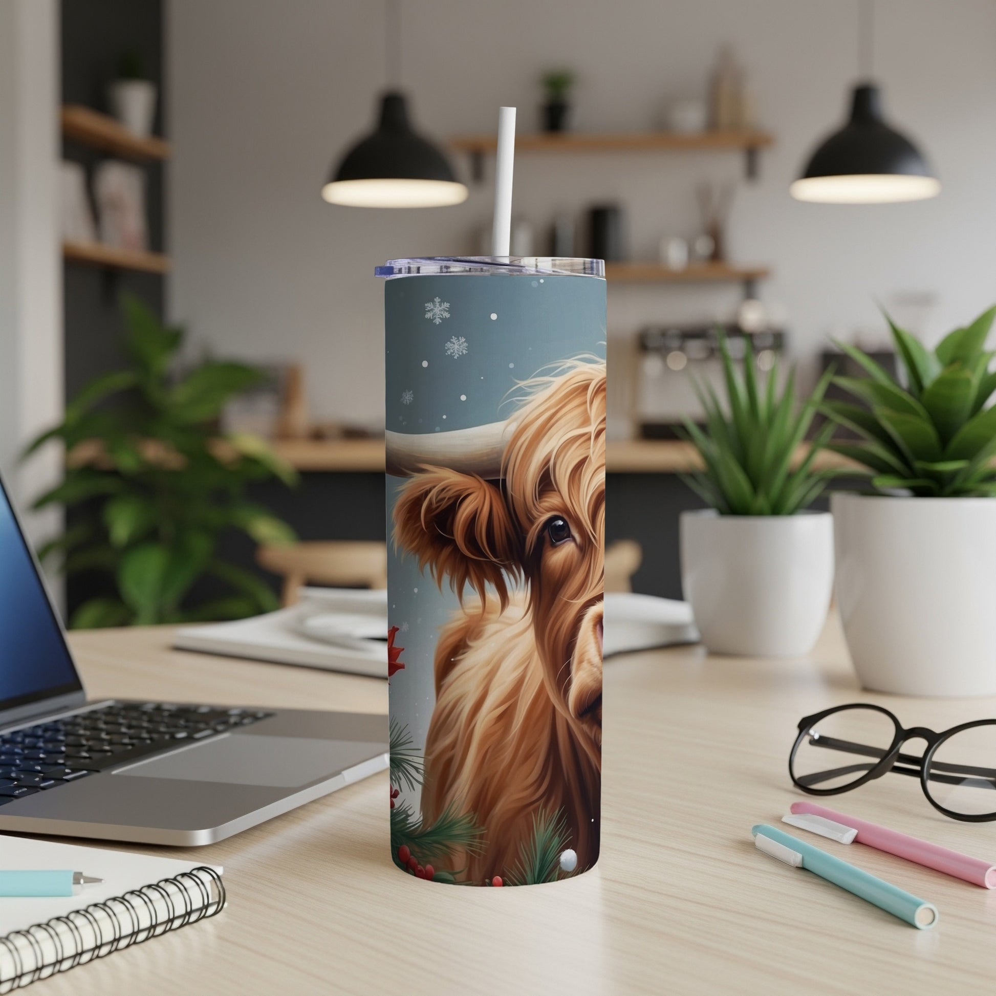 Highland cow with festive holiday decorations on a skinny tumbler.