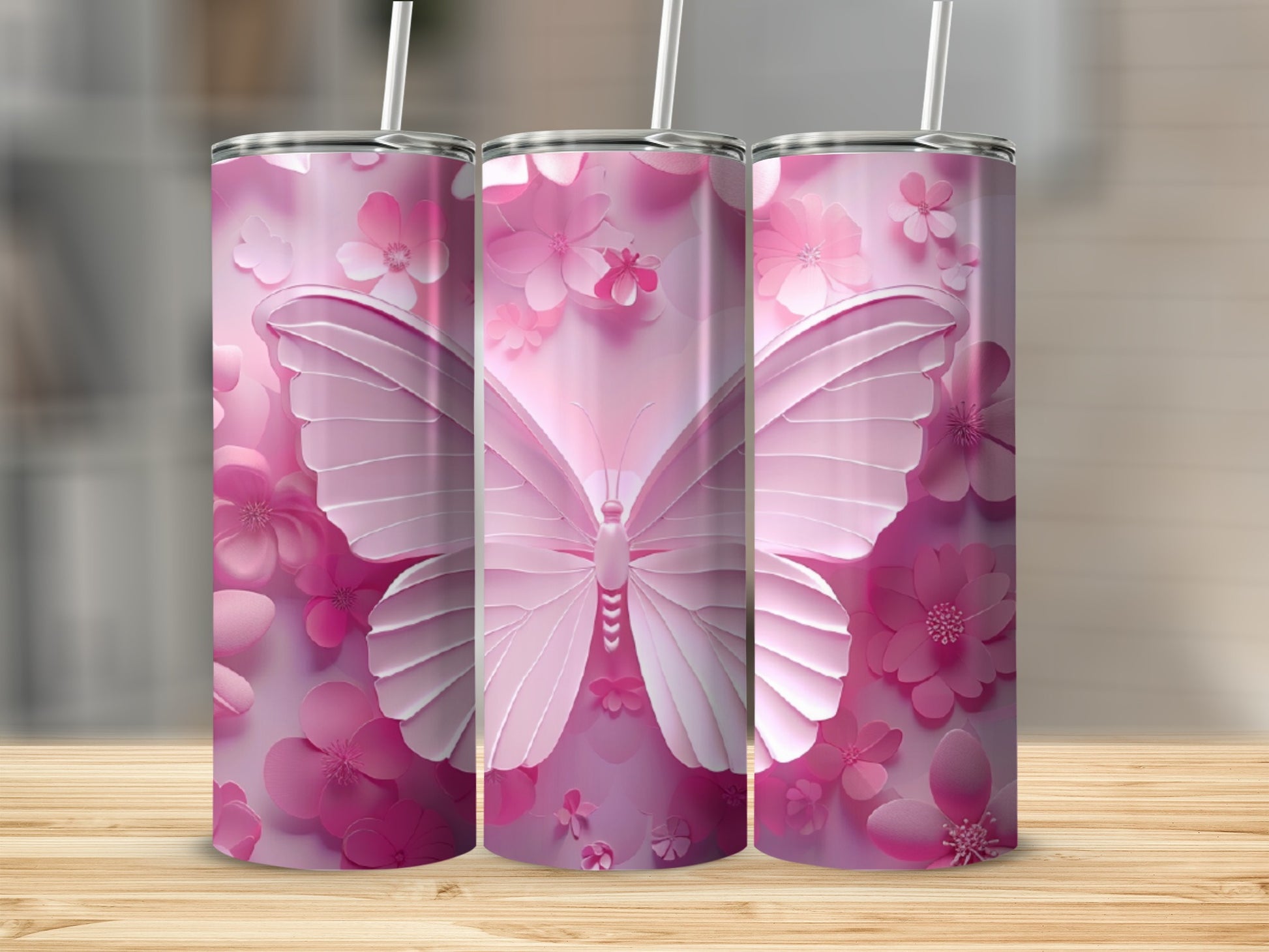 Three pink tumblers with butterfly and flower designs.