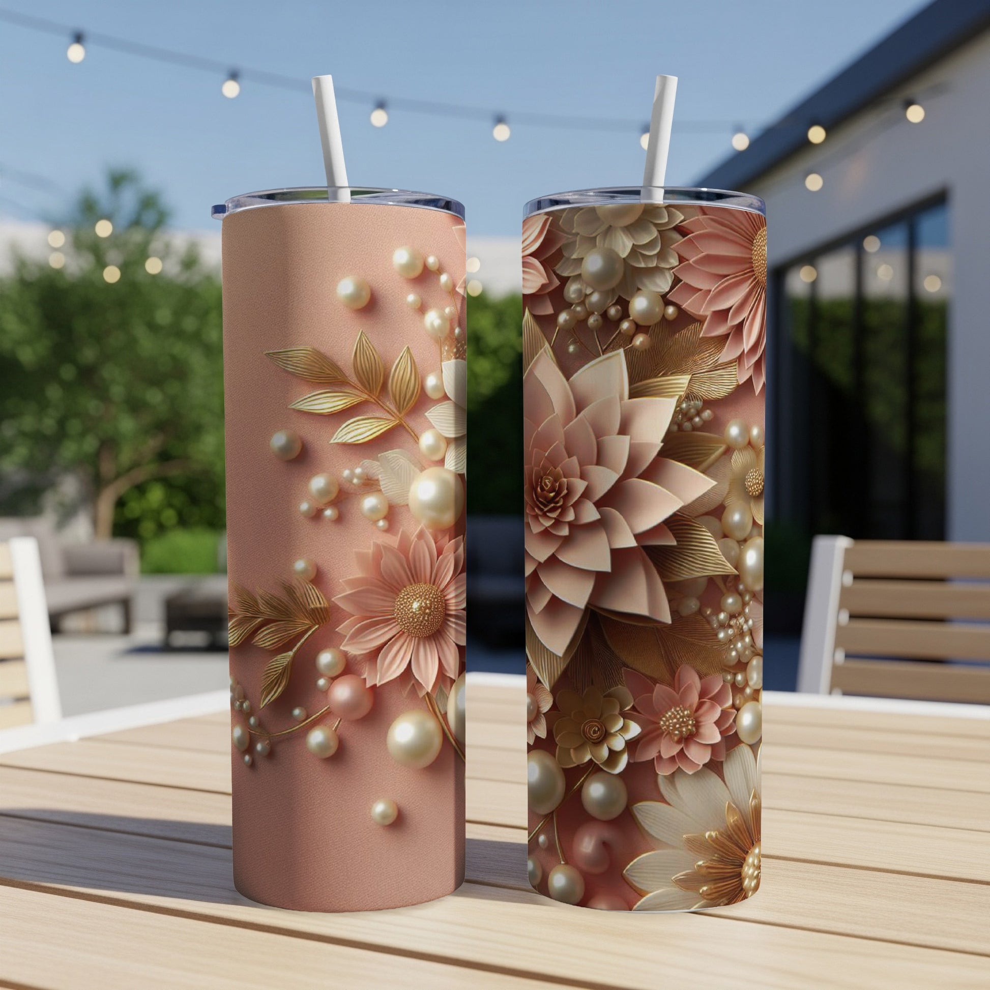 Two rose gold tumblers with floral pearl embellishments on a wooden table.