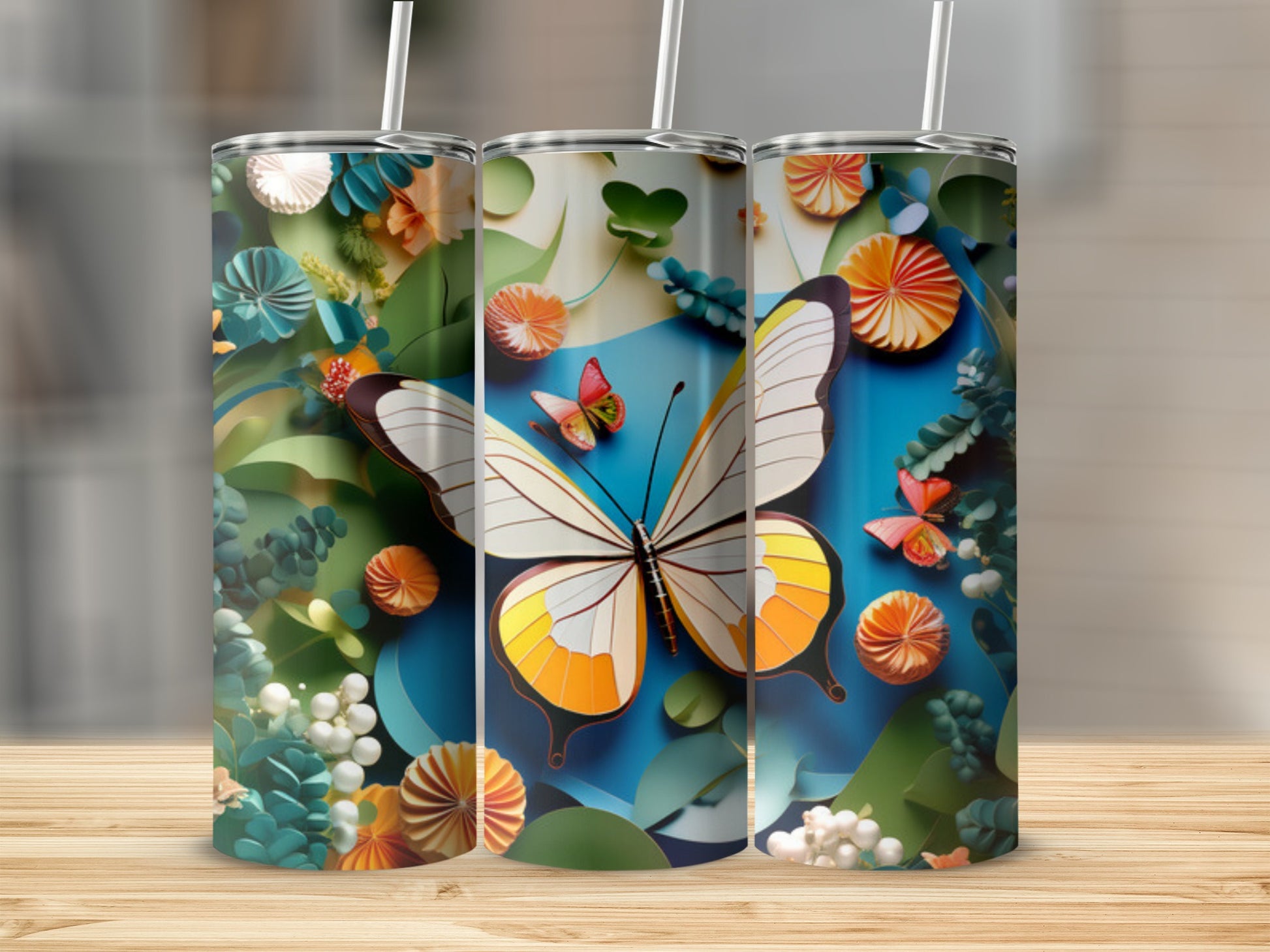 Three tumblers with a butterfly and floral papercraft design.