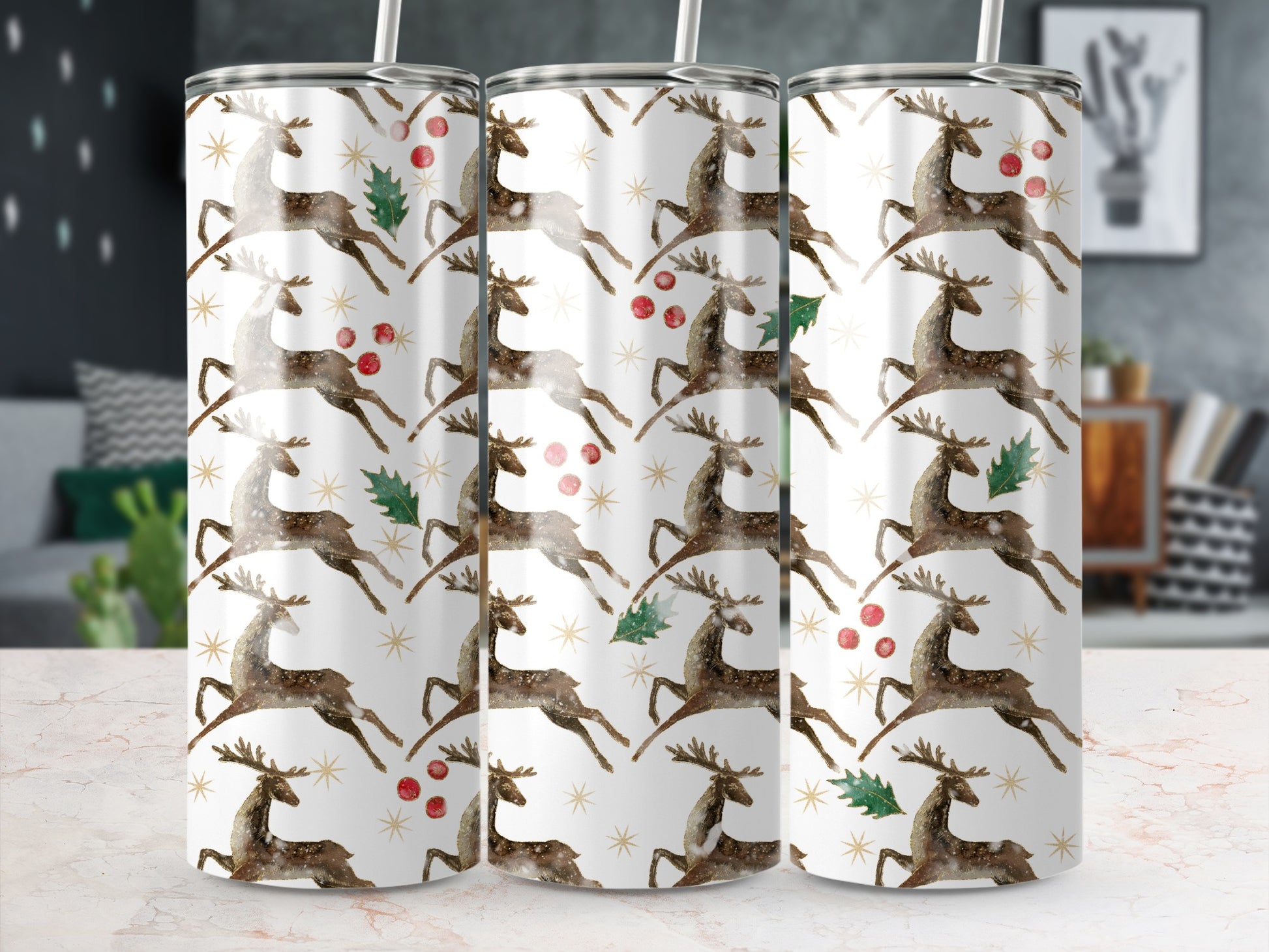 Three tumblers with a repeating pattern of reindeer, holly, and stars.