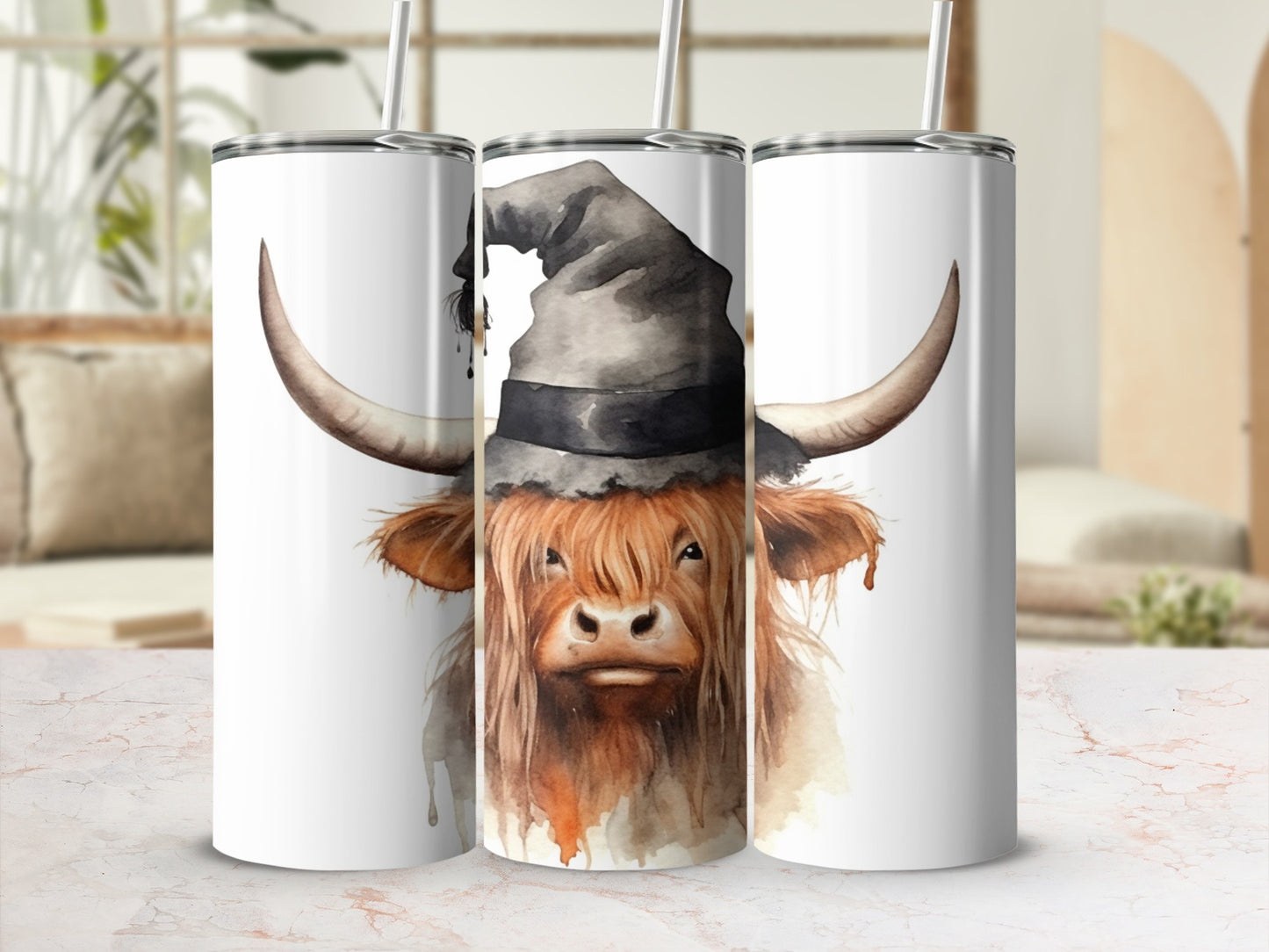 Highland cow wearing a witch hat on a white tumbler with straw.