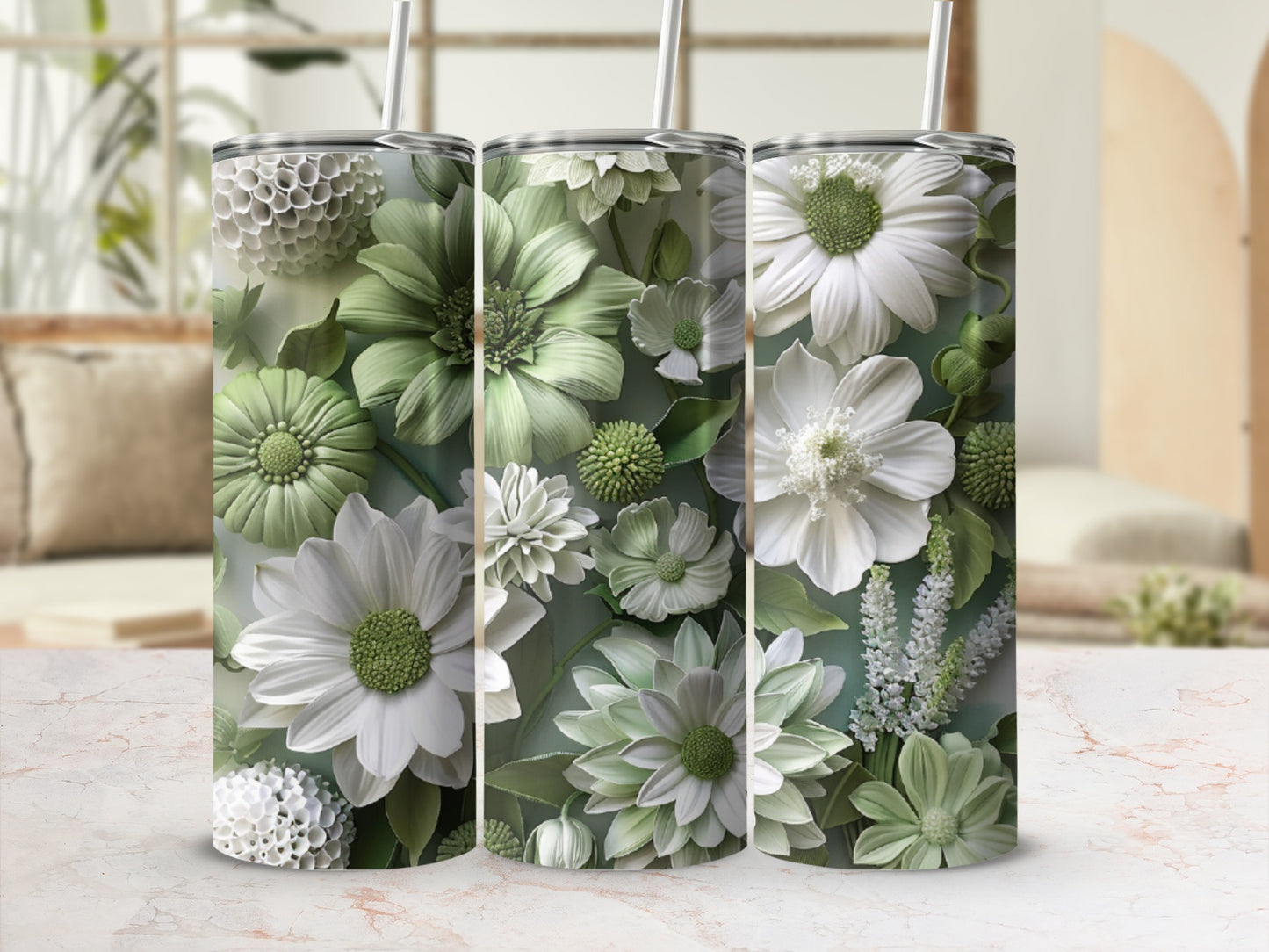 Three tumblers with detailed white and green floral patterns and straws.