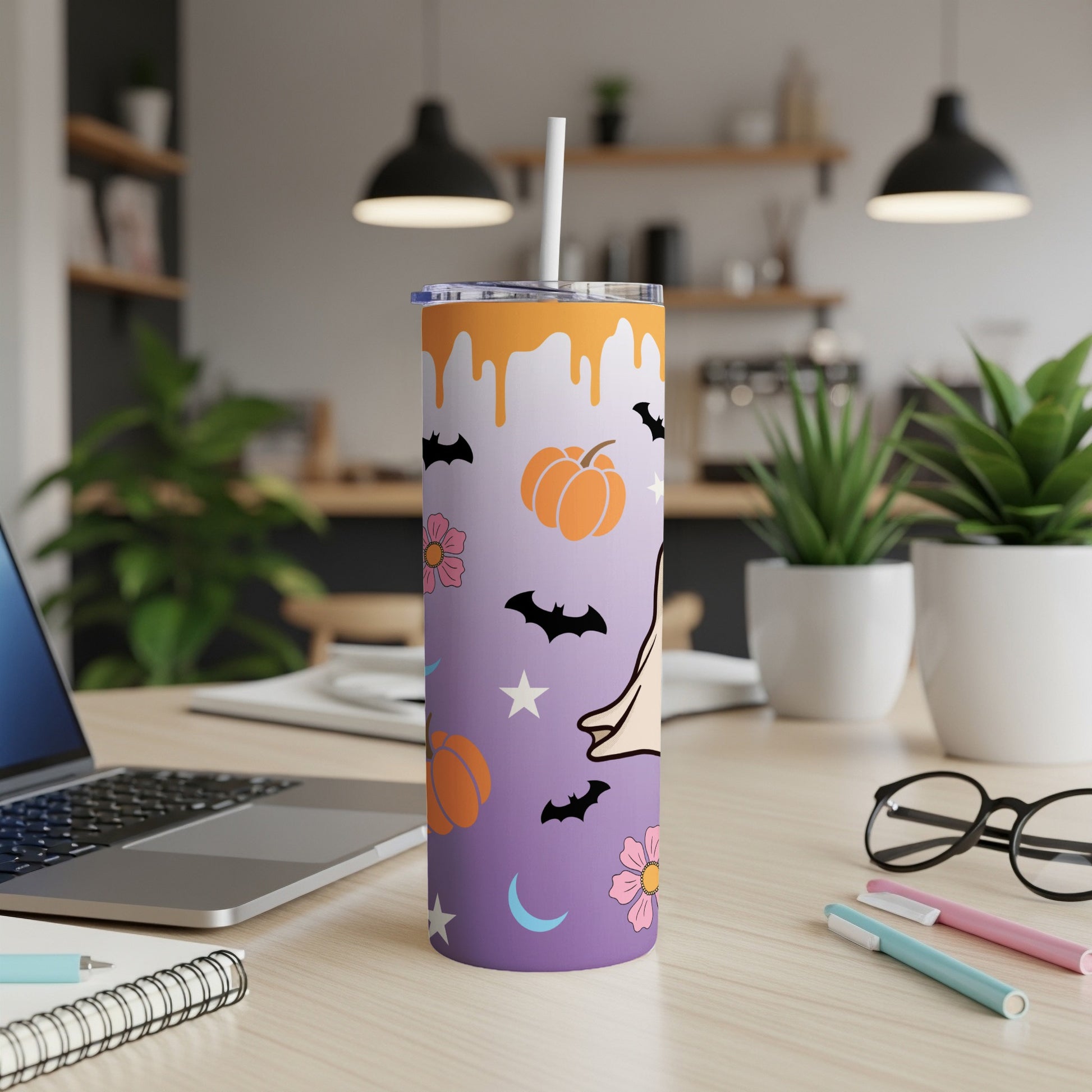 Purple tumbler with Halloween theme: pumpkins, bats, flowers, stars, and a ghost.