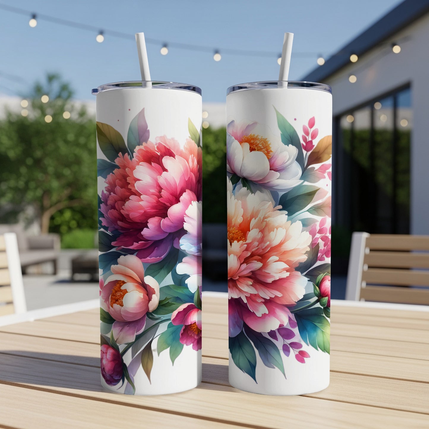 Two white tumblers with a floral peony design on a wooden table.