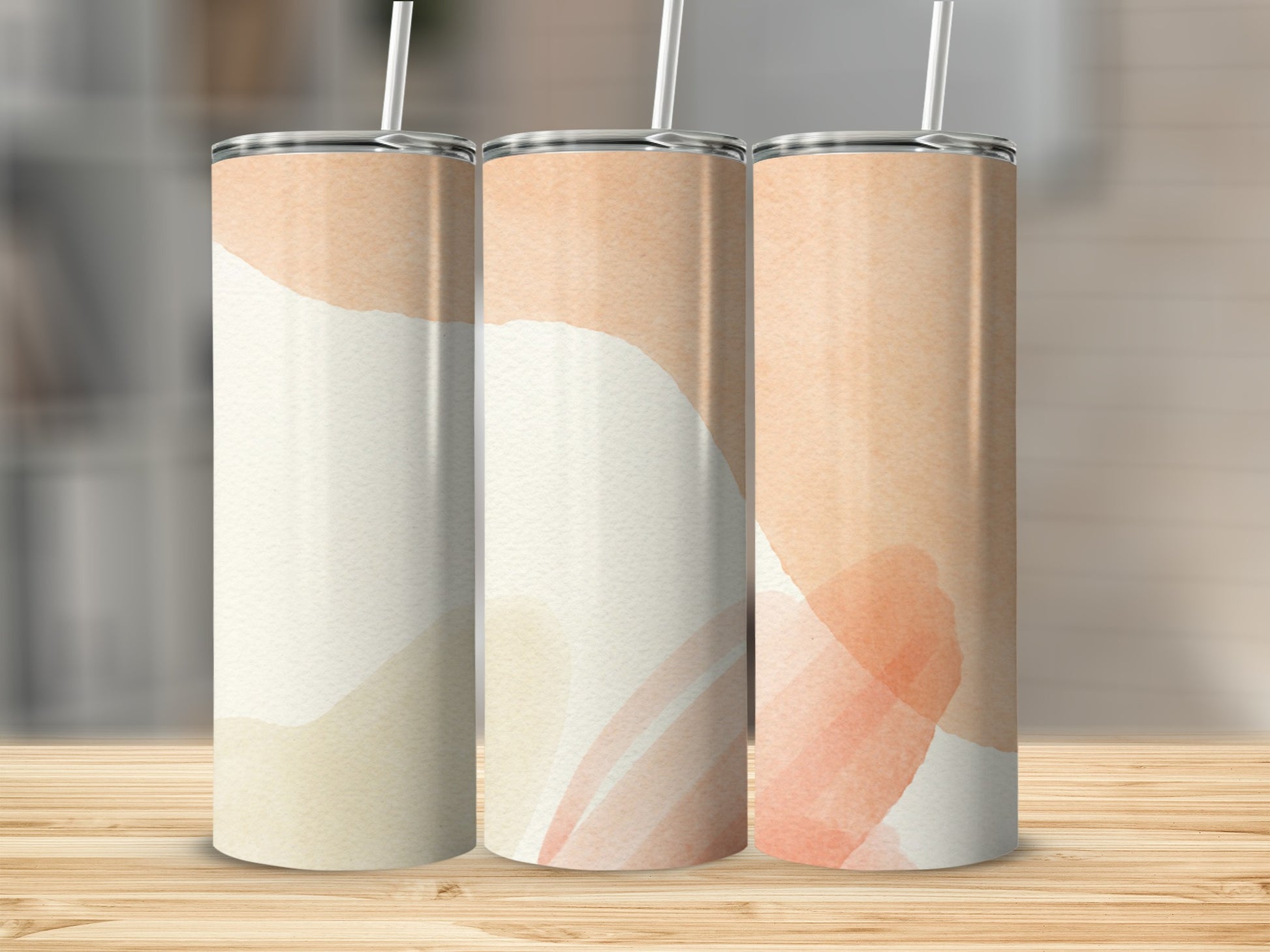 Three tumblers with abstract watercolor designs in beige and peach tones.
