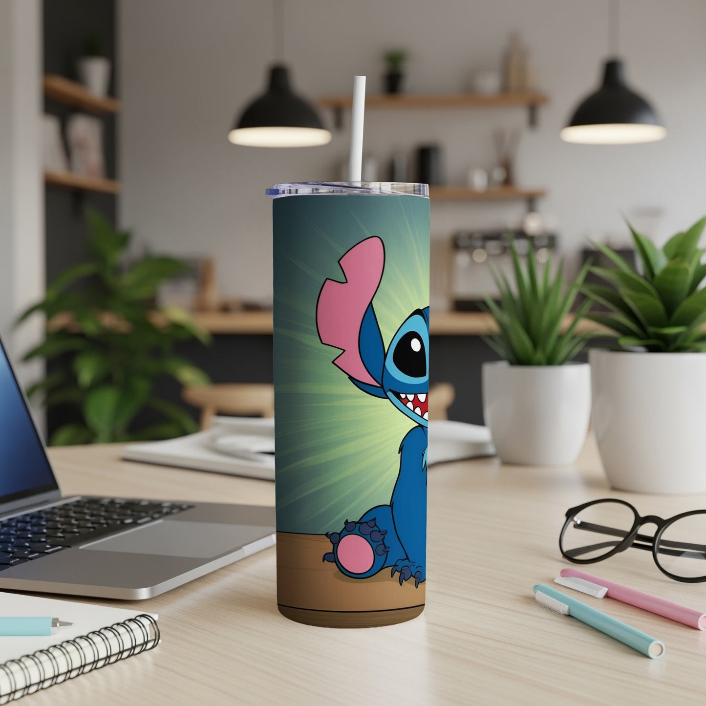 Blue alien character Stitch with wide smile on a teal tumbler with straw.