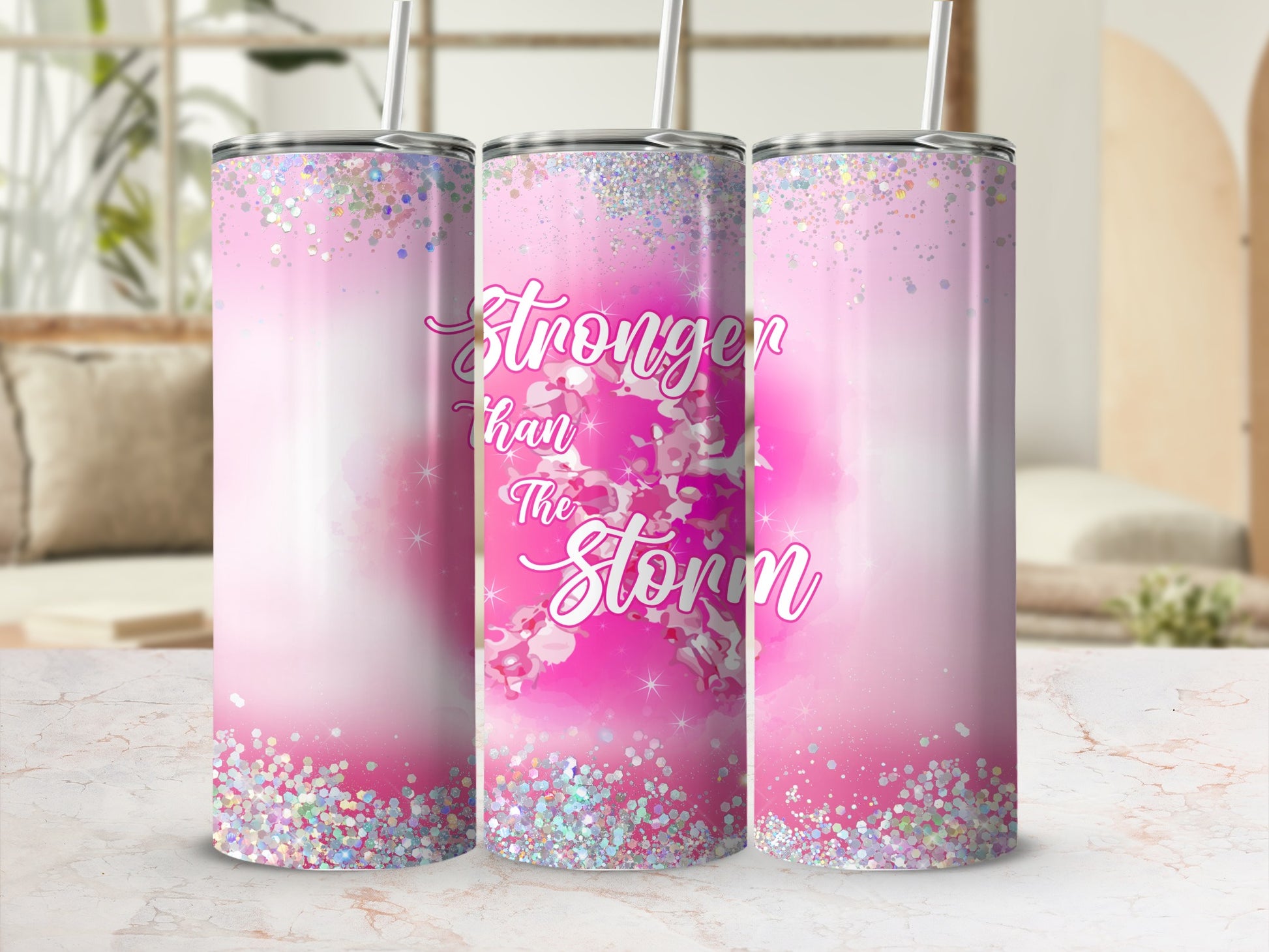 Pink tumbler with glitter and "Stronger than the Storm" text.