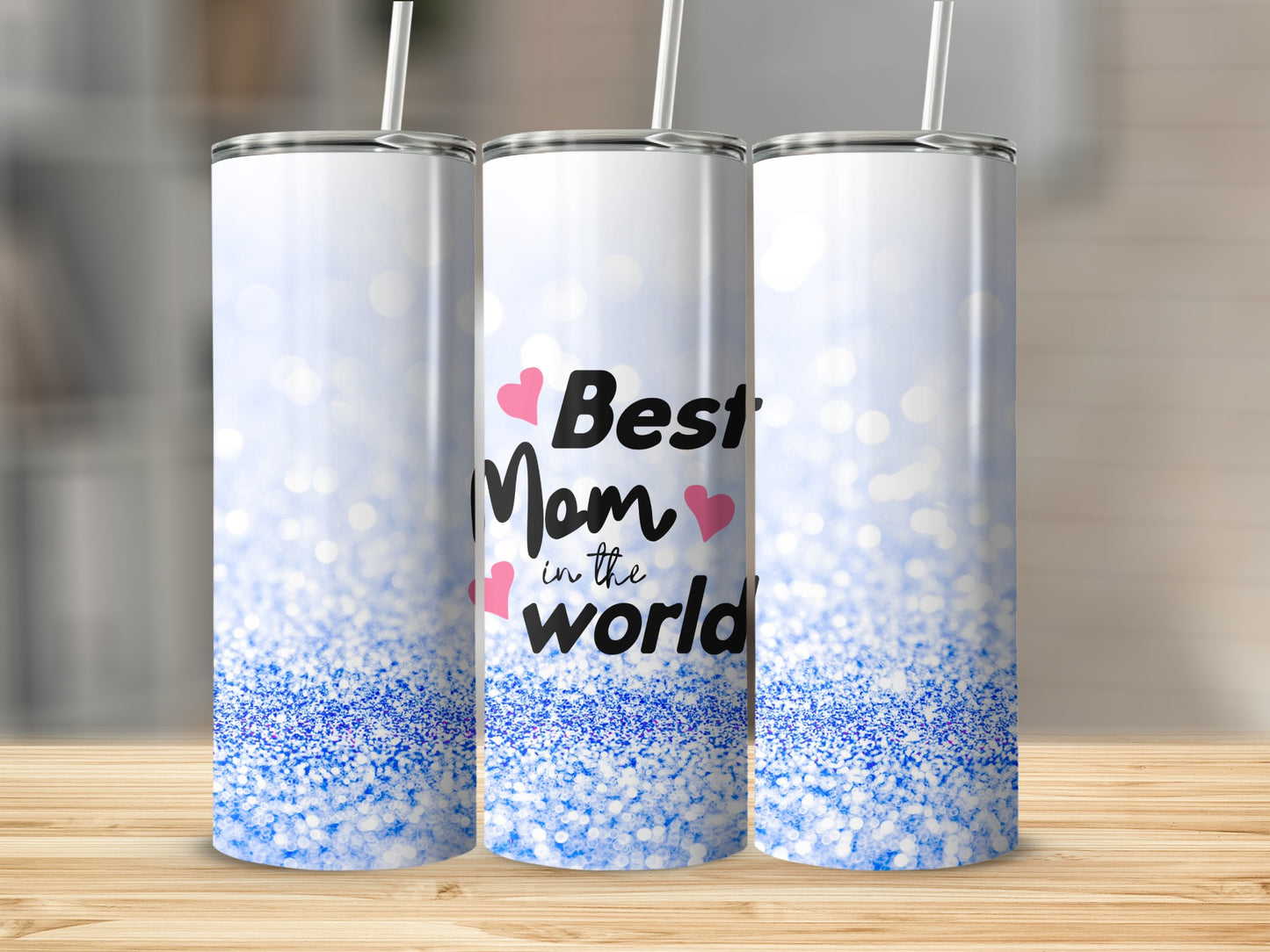 Three skinny tumblers with blue glitter and "Best Mom in the World" text.