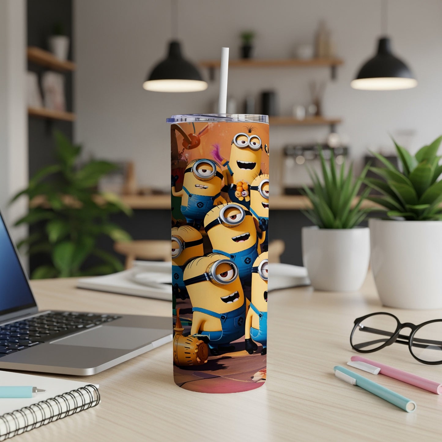 Minions character tumbler cup with a straw in a desk setting.