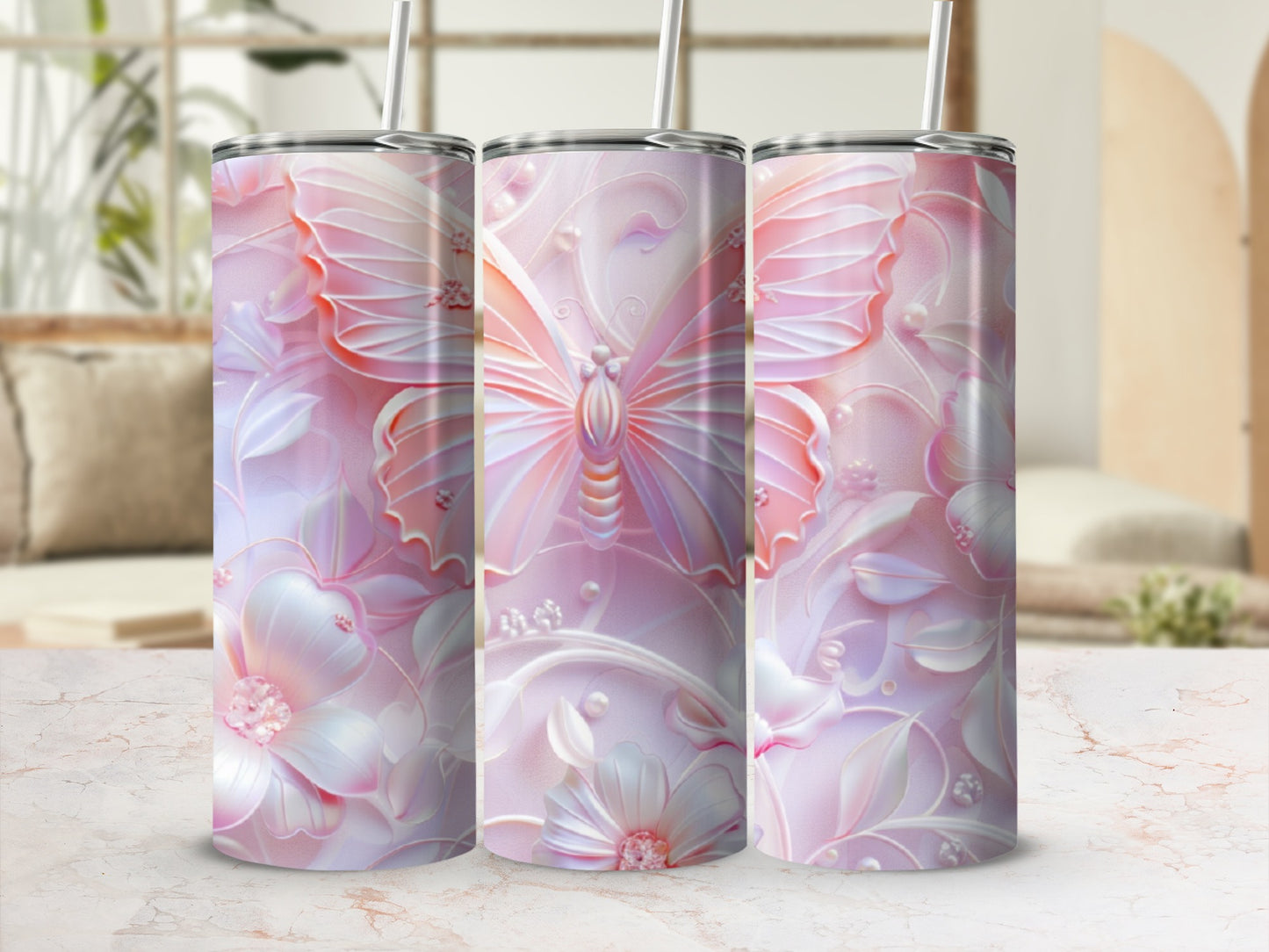 Pink butterfly and floral patterned tumbler with a straw.