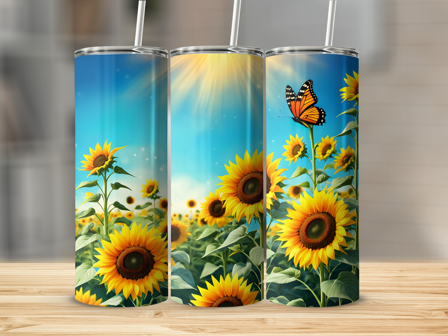 Three tall tumblers featuring sunflowers and a butterfly against a bright sky.