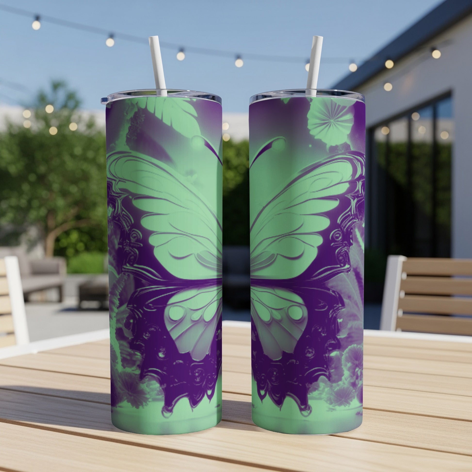 Two purple and green butterfly patterned tumblers on a table.