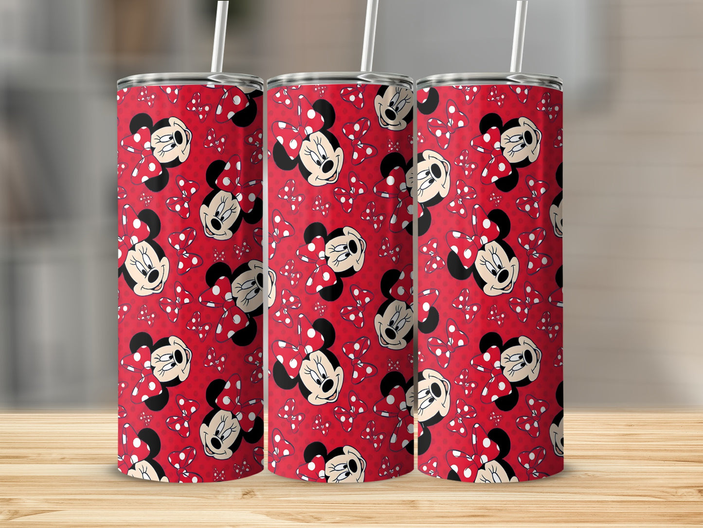Minnie Mouse pattern on three red stainless steel tumblers with straws.