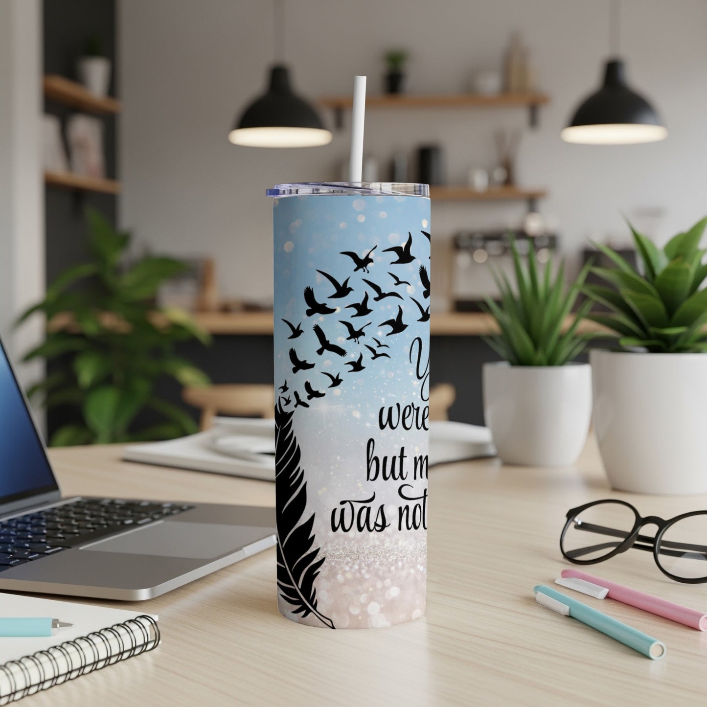 Feather and bird silhouette tumbler with "you were here but my story was not" text.