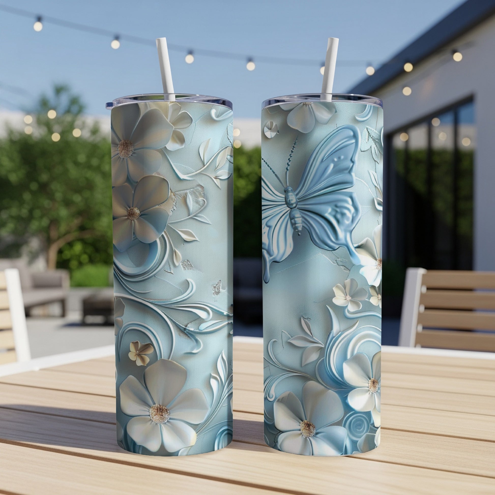 Two light blue tumblers with embossed floral and butterfly designs.