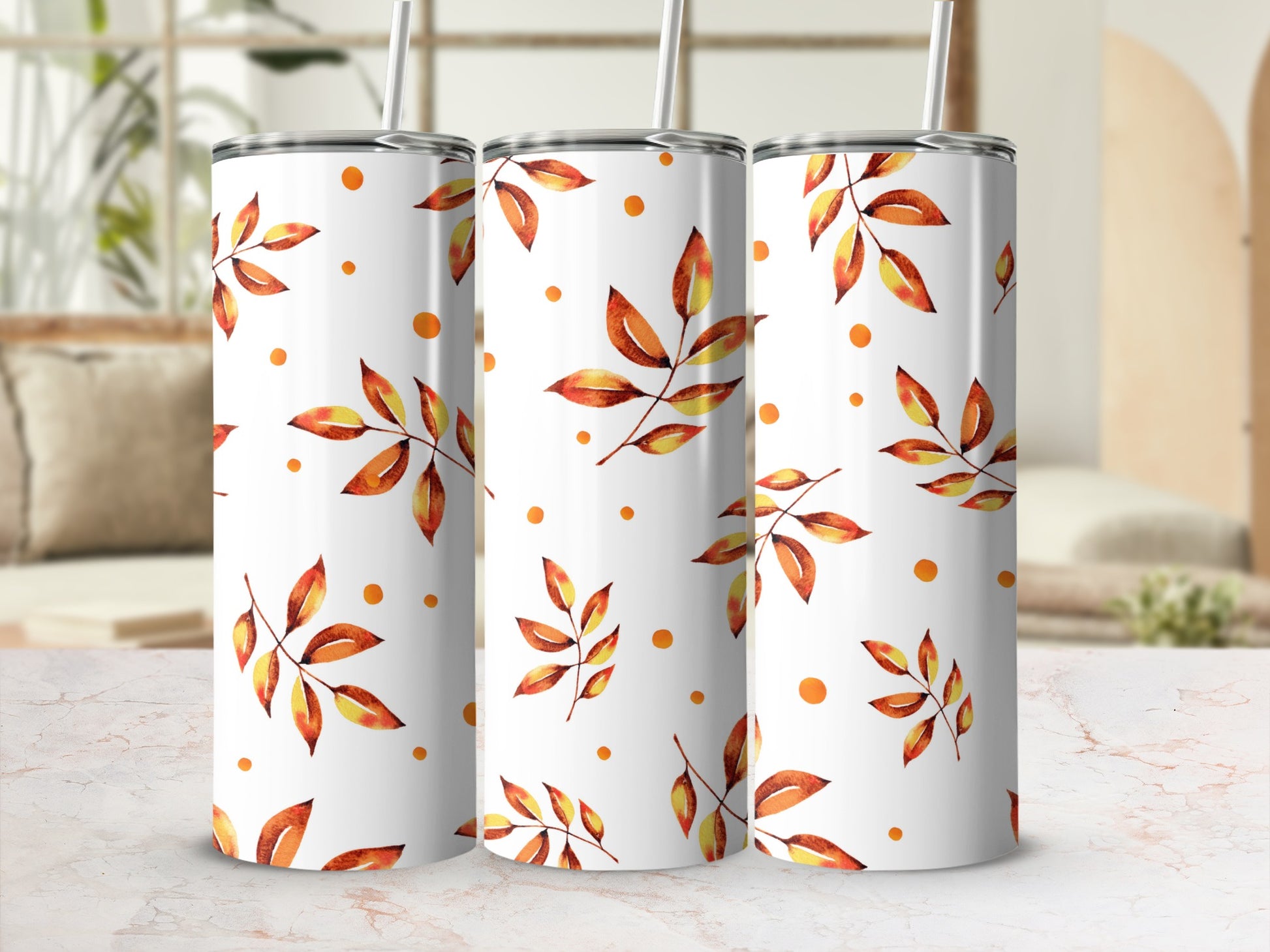 White tumbler with repeating watercolor autumn leaves and dots pattern.