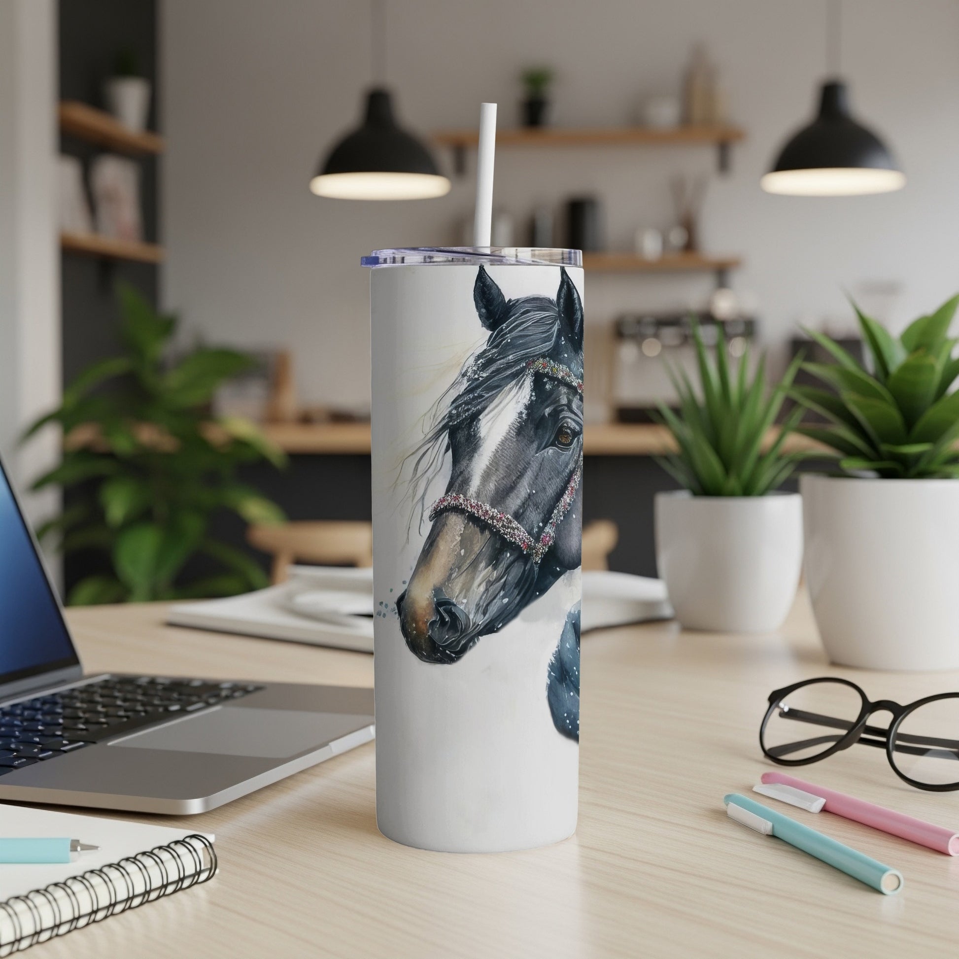 White tumbler with horse illustration and straw on desk.