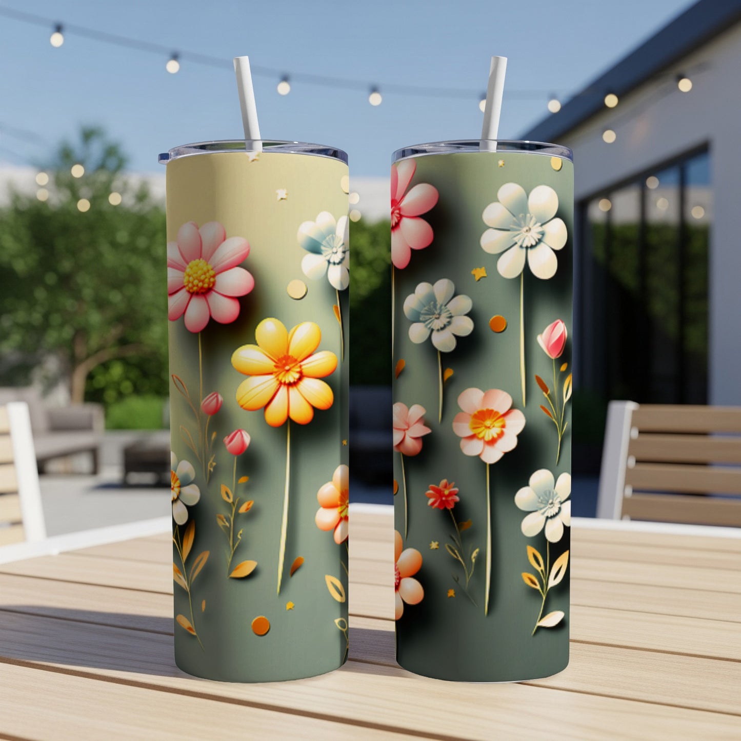 Two tall tumblers with a floral design sit on a table.