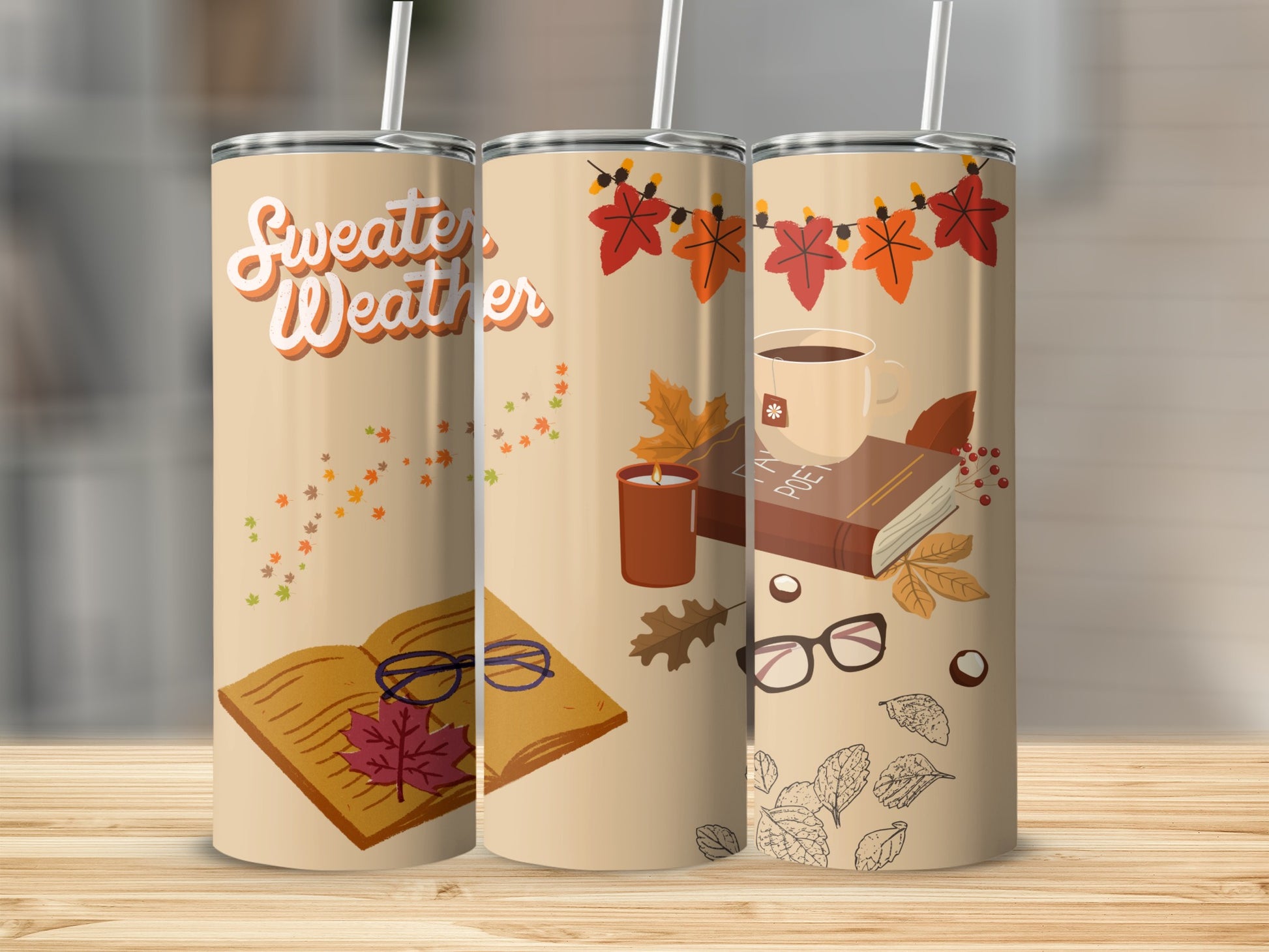 Tan tumbler with "Sweater Weather" text, autumn leaves, books, and glasses.