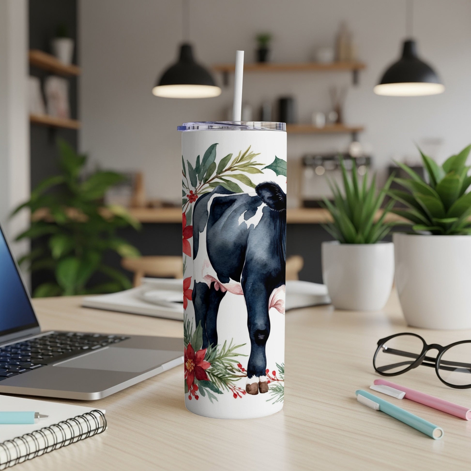 White tumbler with cow, holly, and poinsettia design.