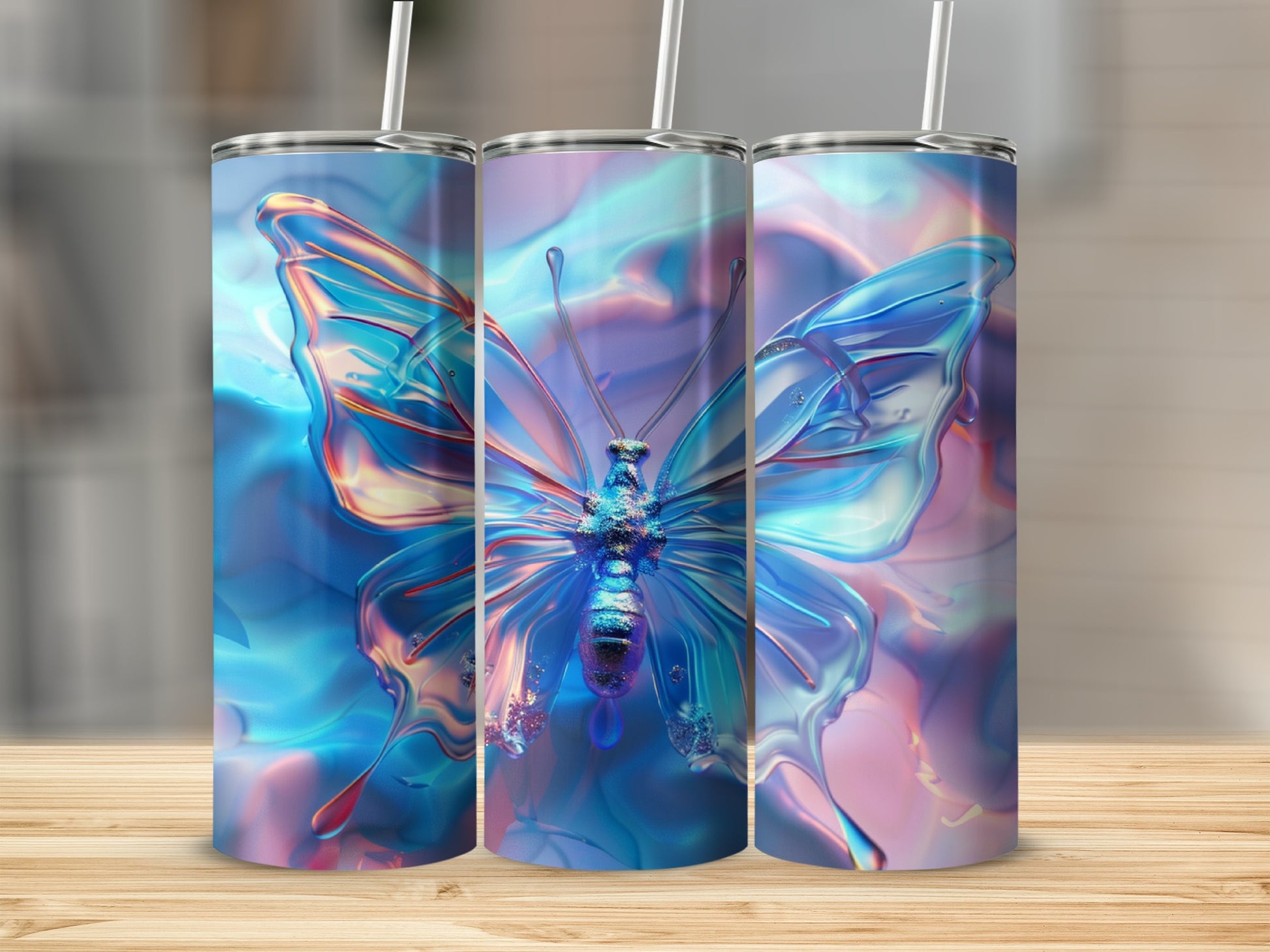 Three iridescent tumblers with butterfly designs on a wooden surface.
