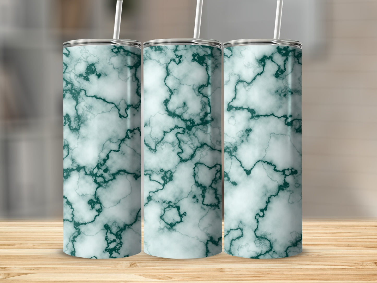 Three tumblers with a green marble pattern stand on a wooden surface.