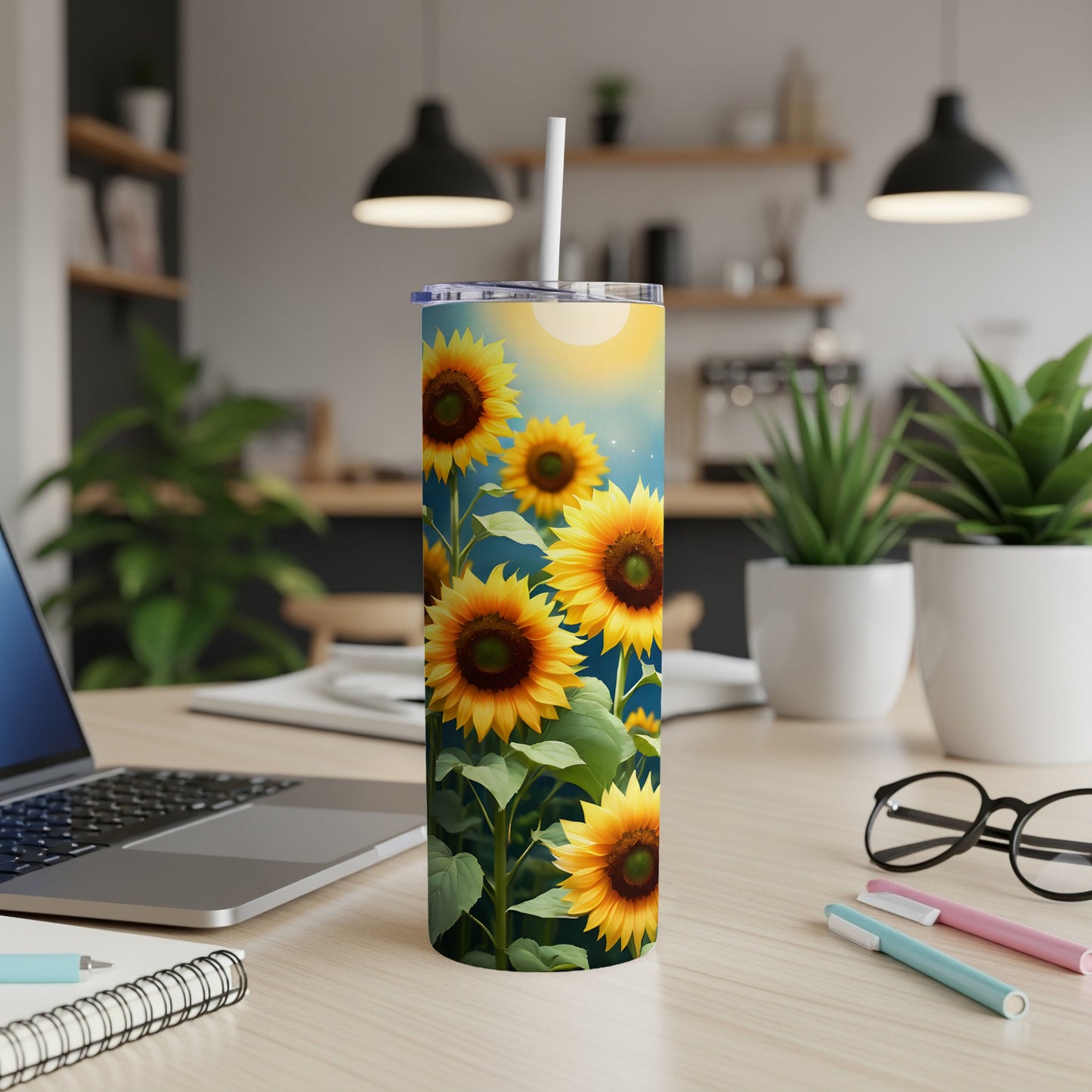Sunflower tumbler with white straw on a wooden desk.