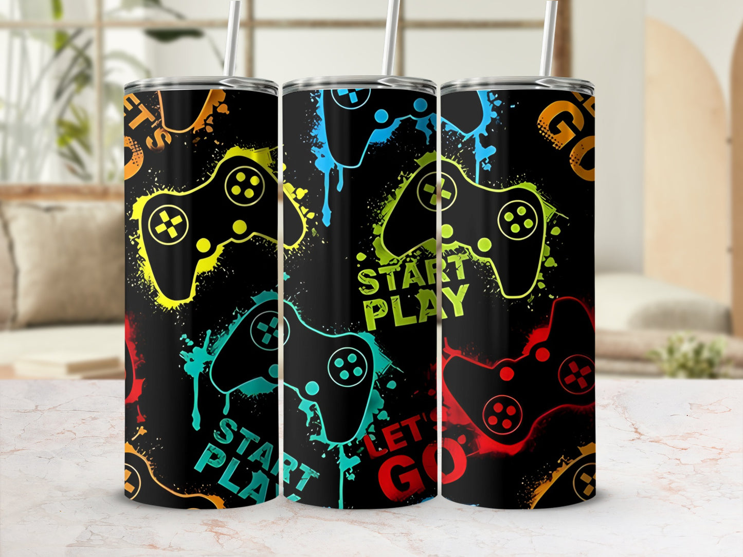 Three tumblers with a colorful video game controller design and text.