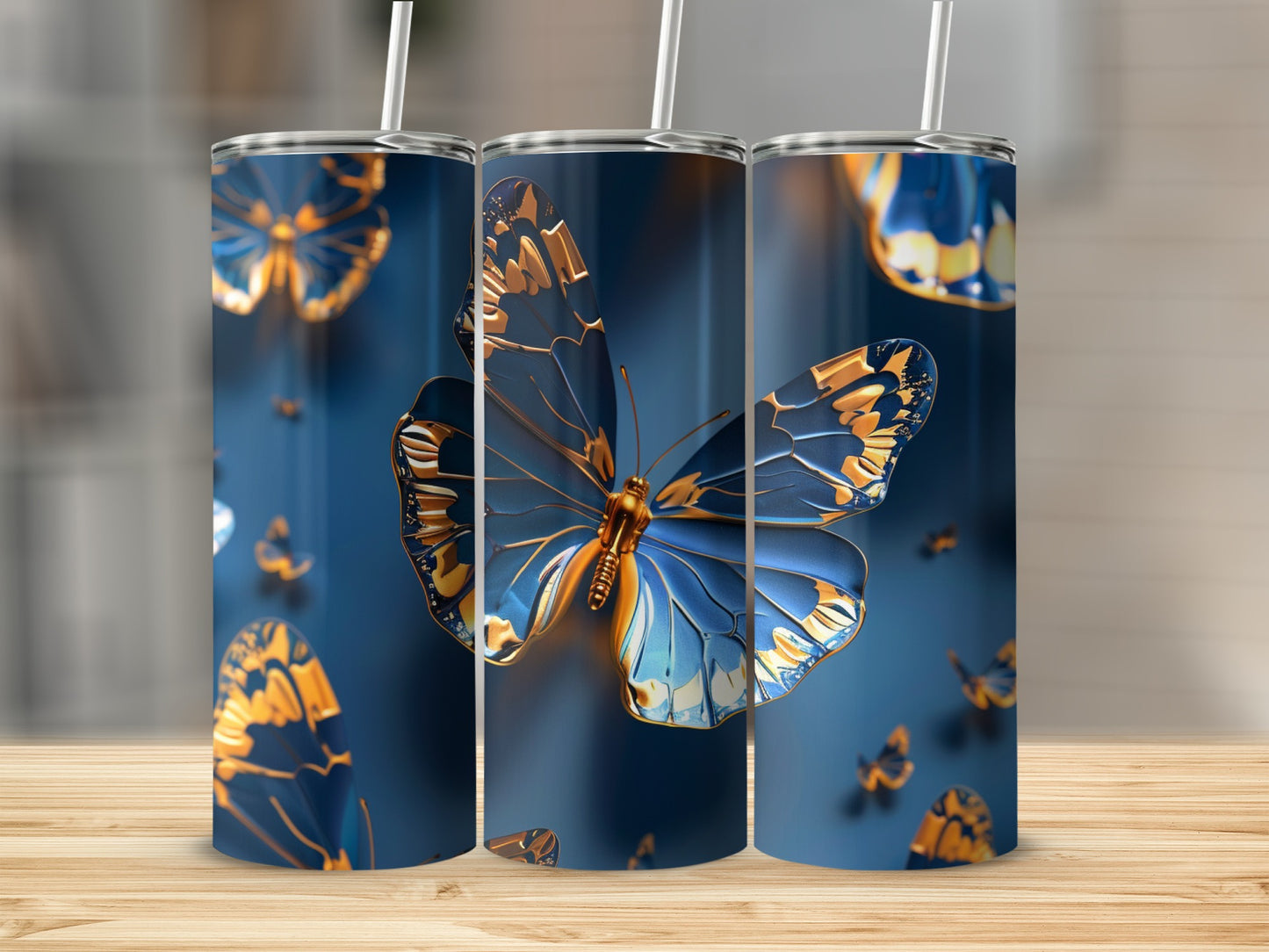 Three tumblers with detailed blue and gold butterfly designs.