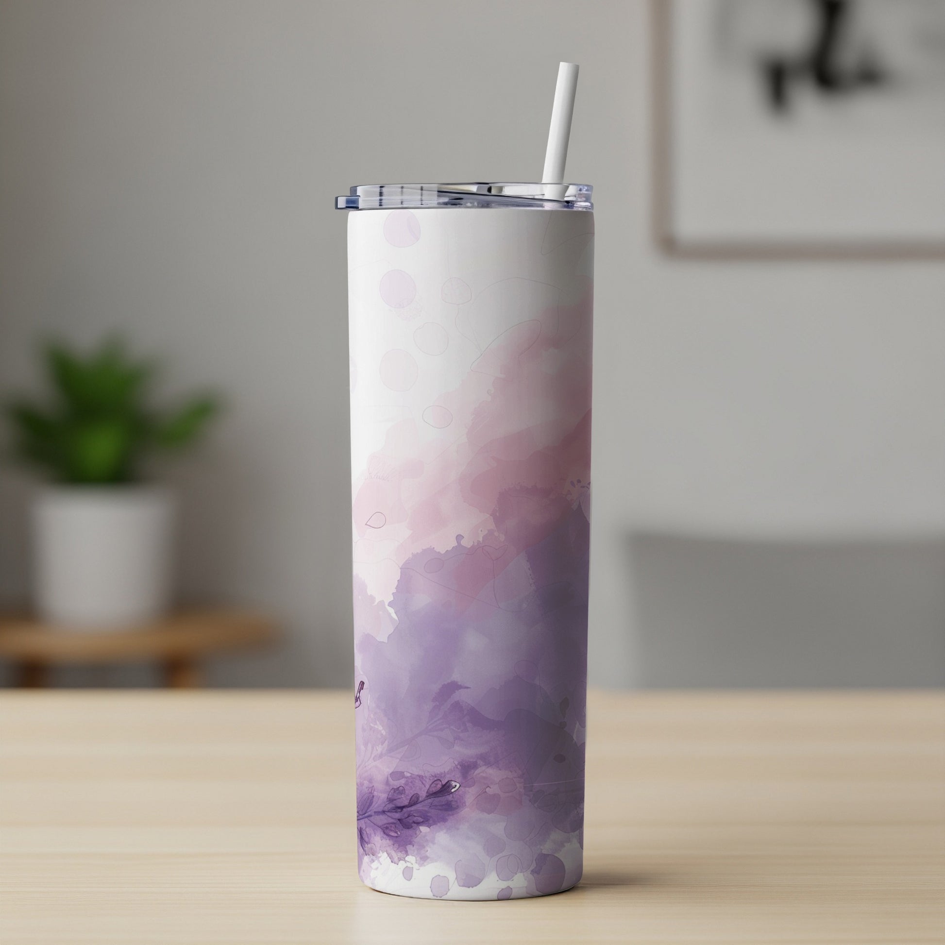 Tumbler with abstract purple and pink watercolor design and straw.