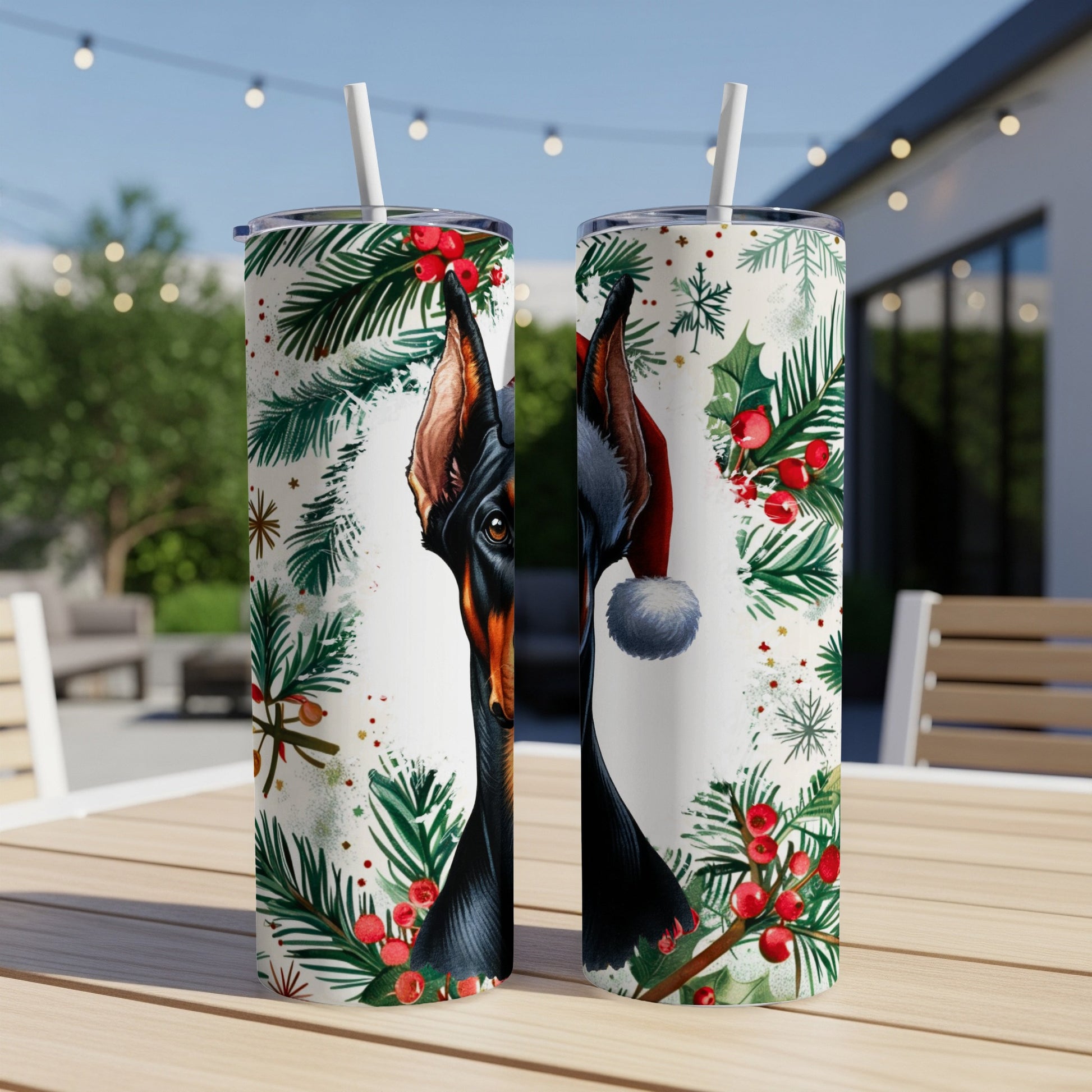 Doberman in Santa hat with Christmas foliage, on two tumblers.