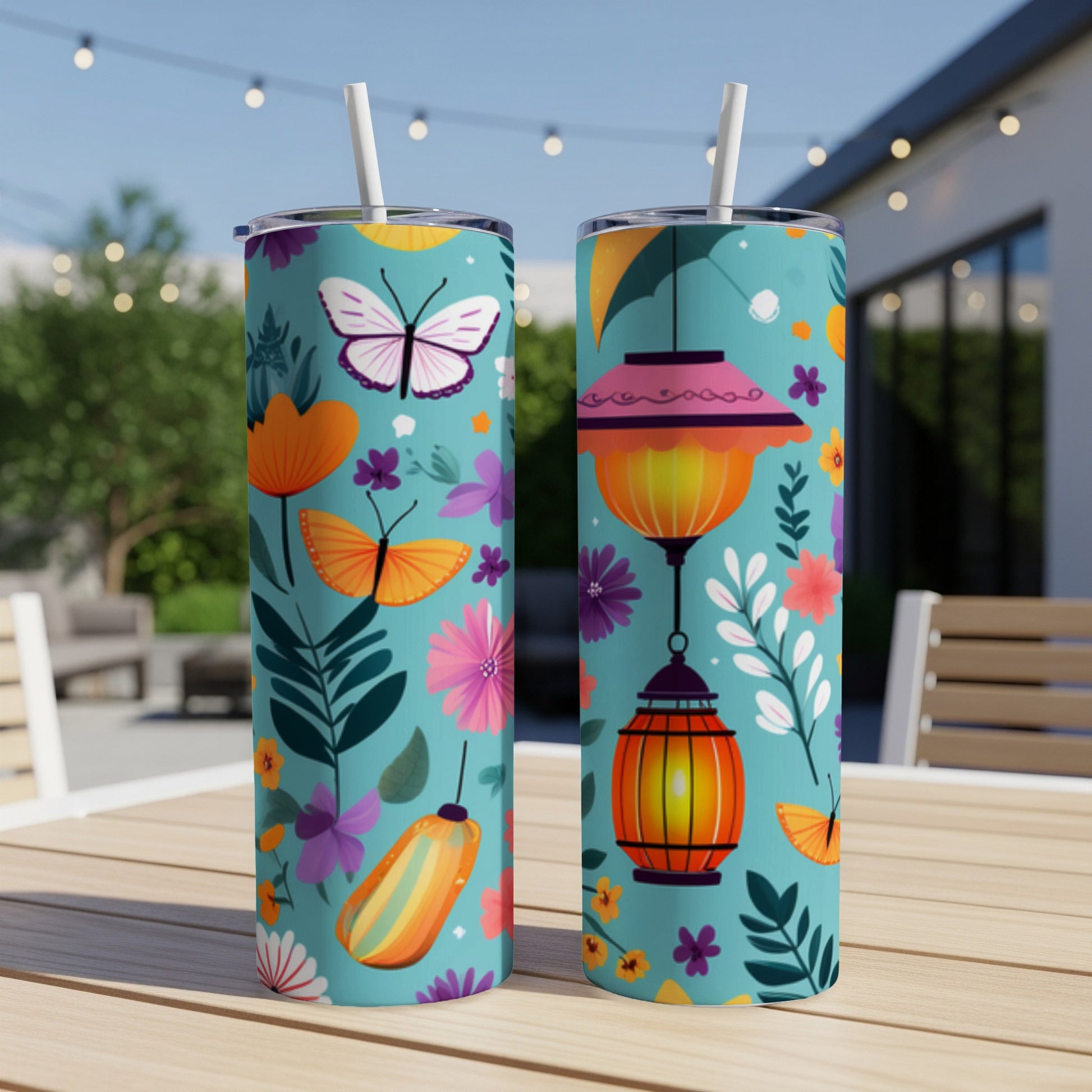 Two tumblers with floral and butterfly patterns on a table.