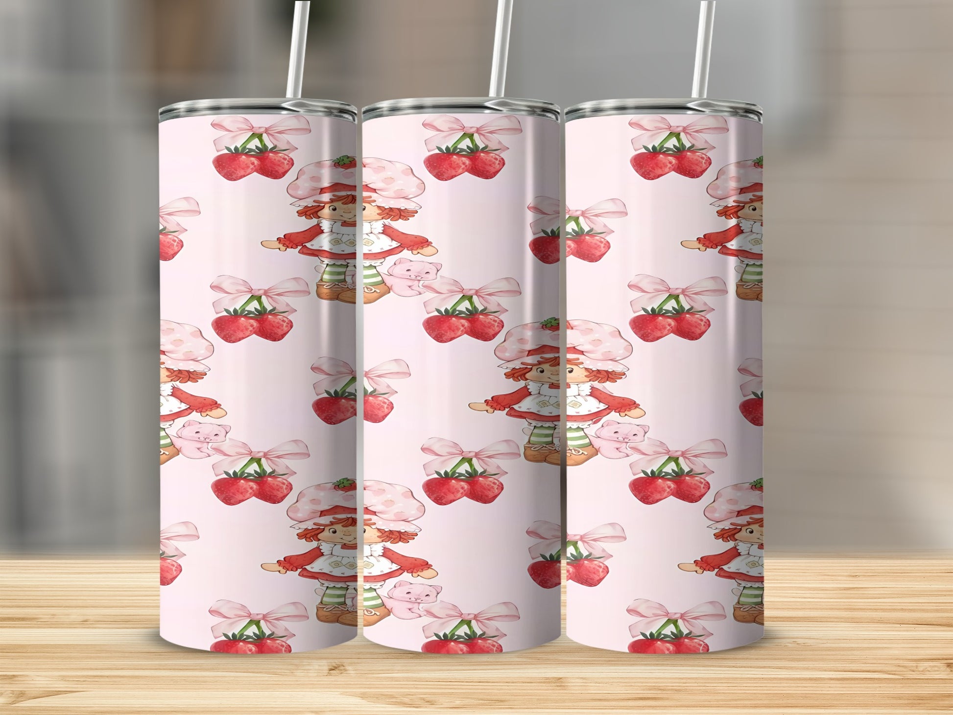 Strawberry Shortcake pattern on three skinny tumblers with straws.