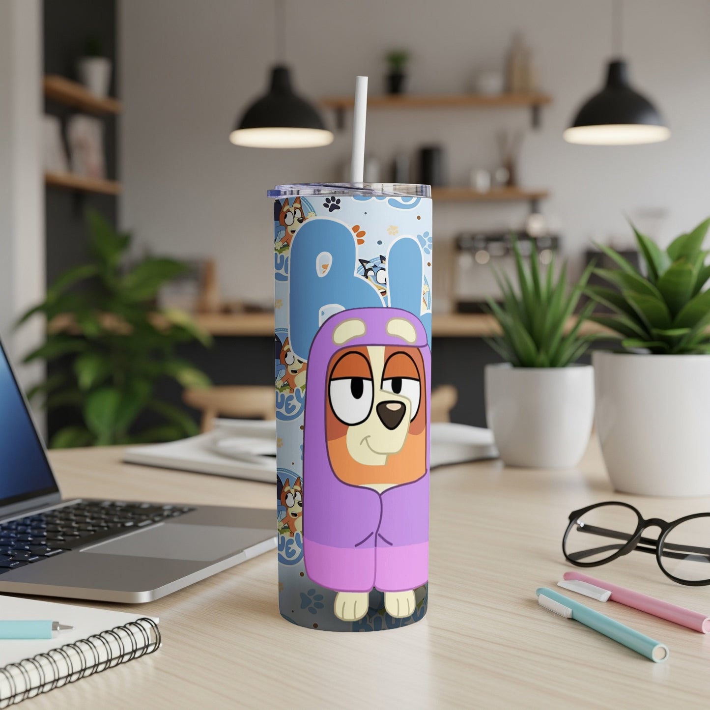 Bluey character on a patterned blue tumbler with a straw.