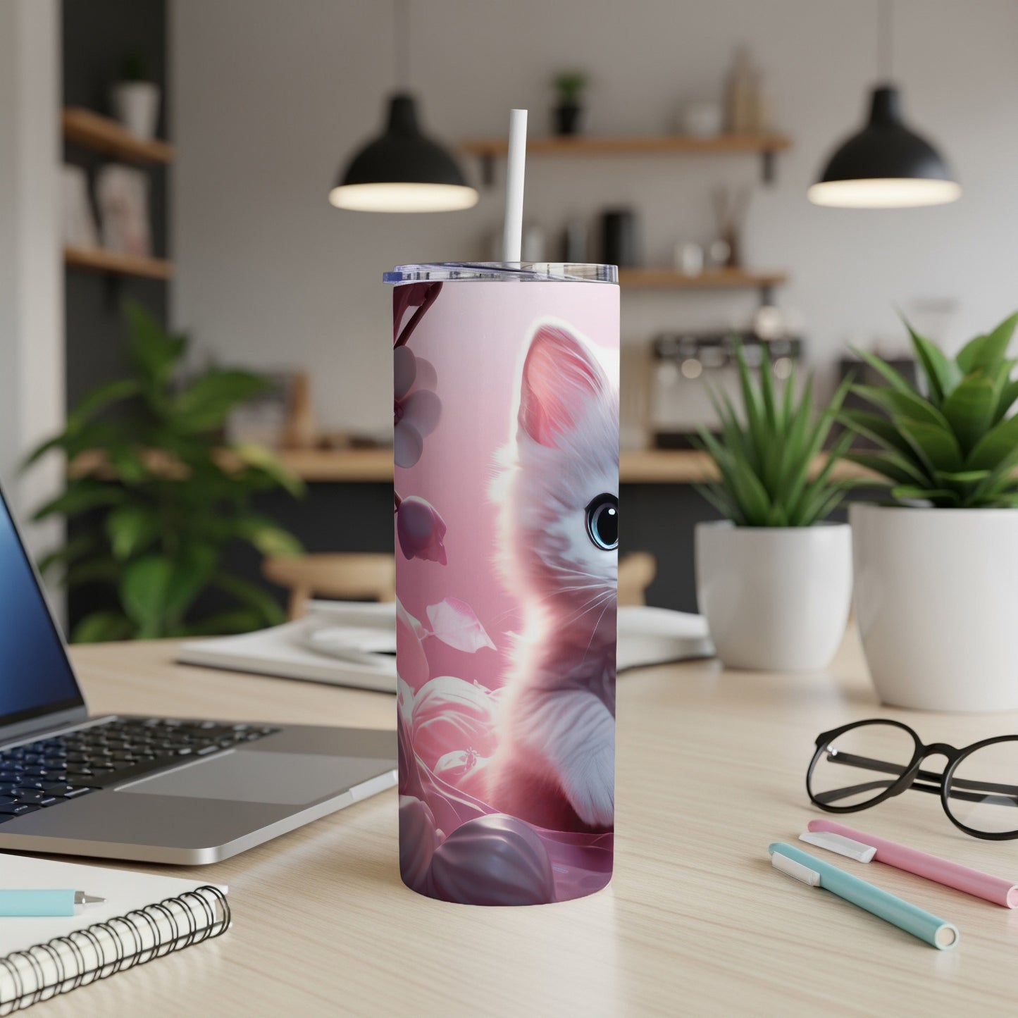 Pink tumbler with a cute white kitten face illustration and straw.