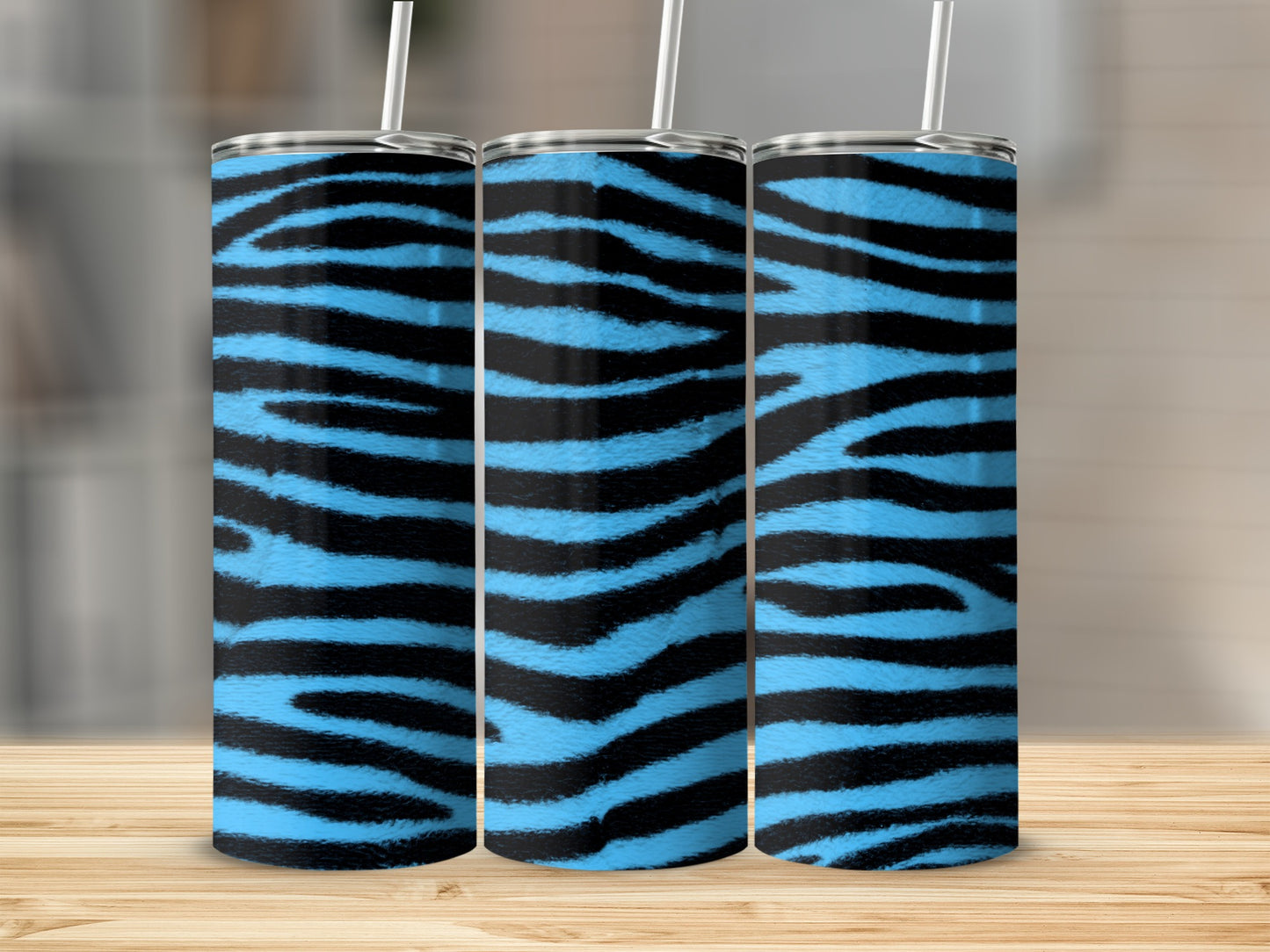 Three tall tumblers with blue and black zebra stripes stand side-by-side.