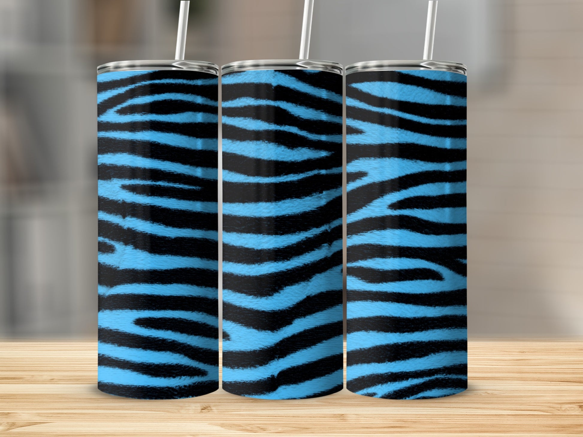 Three tall tumblers with blue and black zebra stripes stand side-by-side.