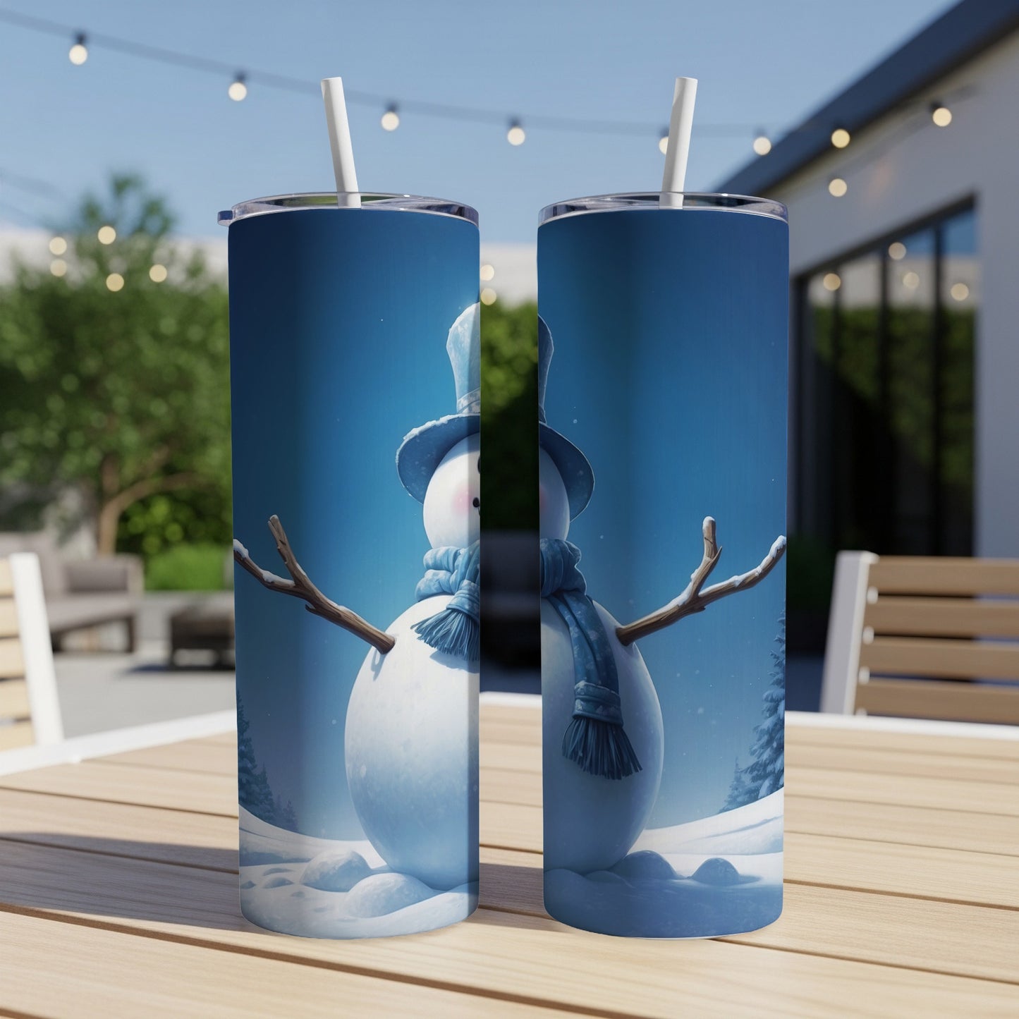 Two slim tumblers with a snowman design sit on a wooden table.