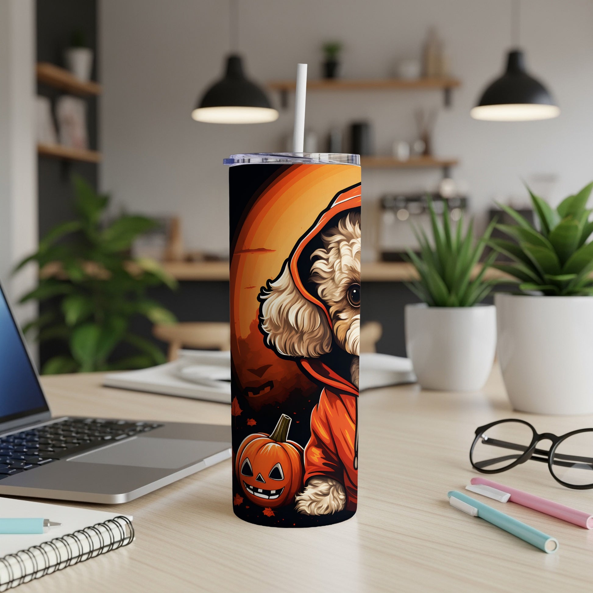 Tumbler with cartoon dog in costume beside a jack-o'-lantern.