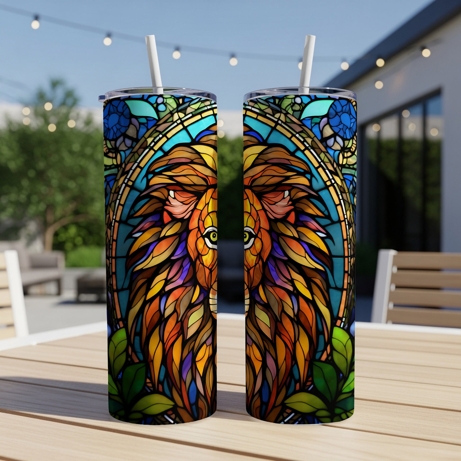 Two tumblers with a stained-glass lion design on a table.