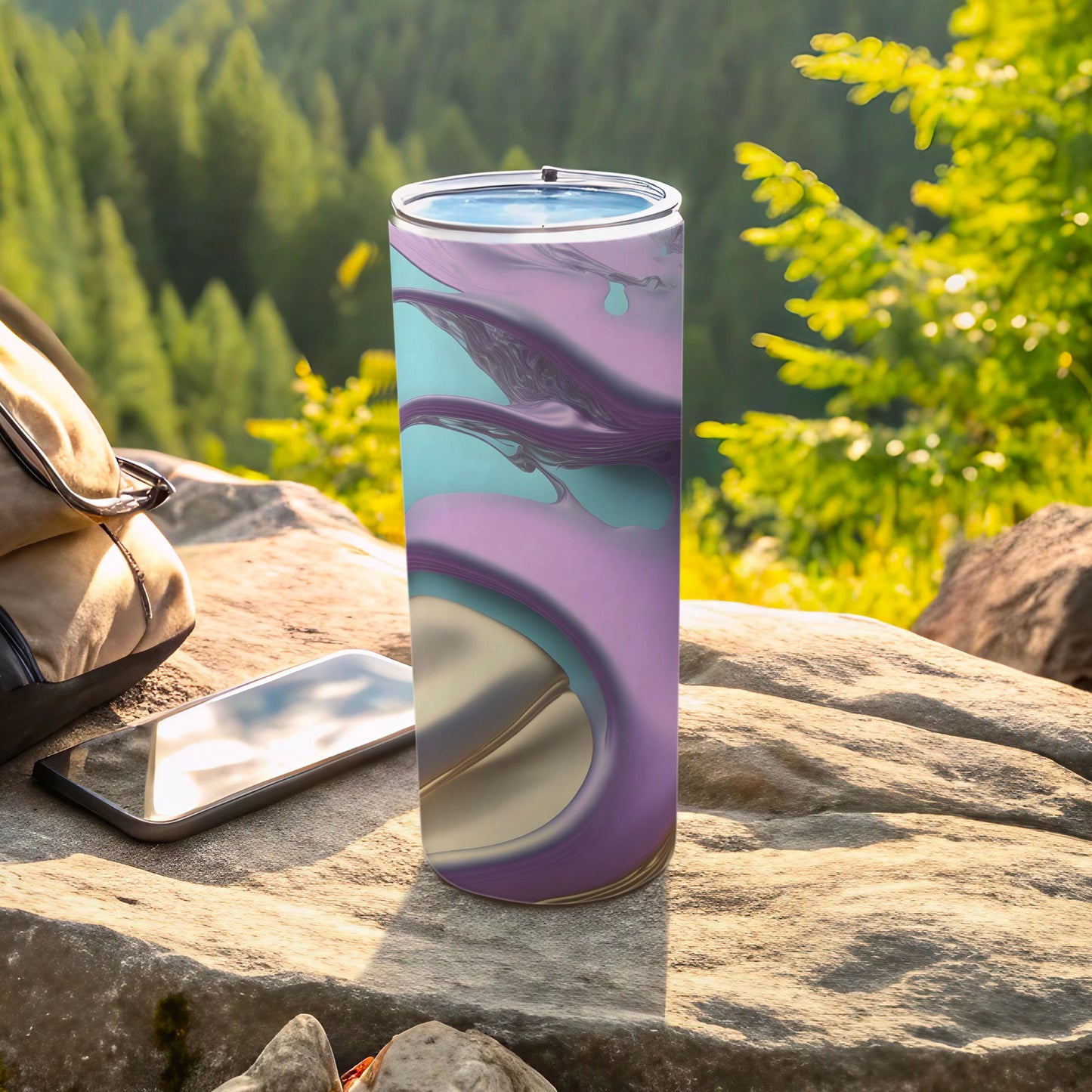Purple and blue abstract design on a tall tumbler with a phone and bag.