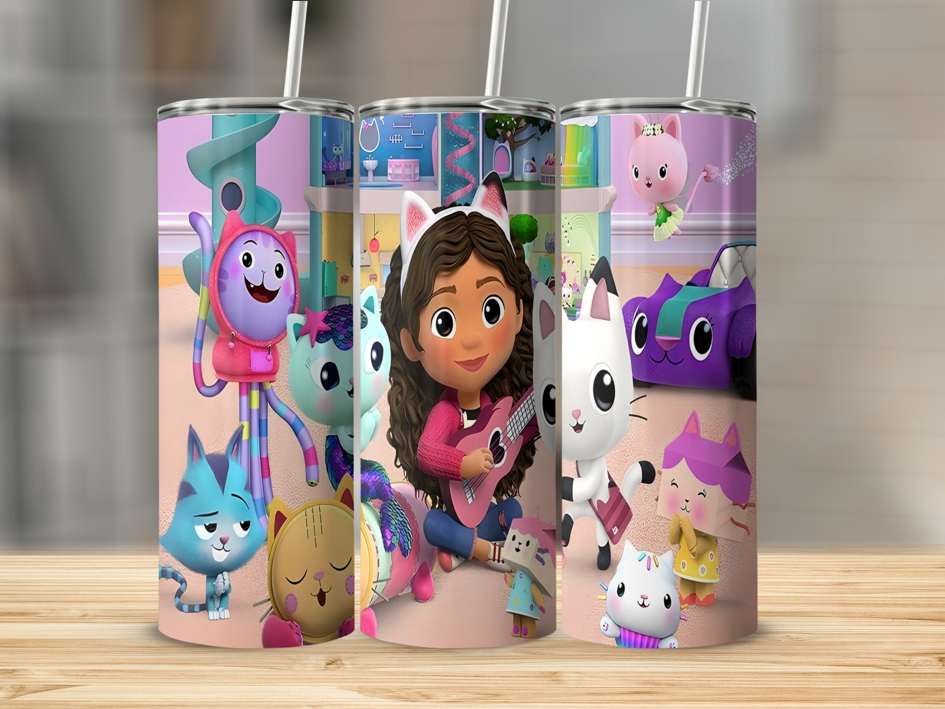 Gabby's Dollhouse characters on colorful tumbler with straws.
