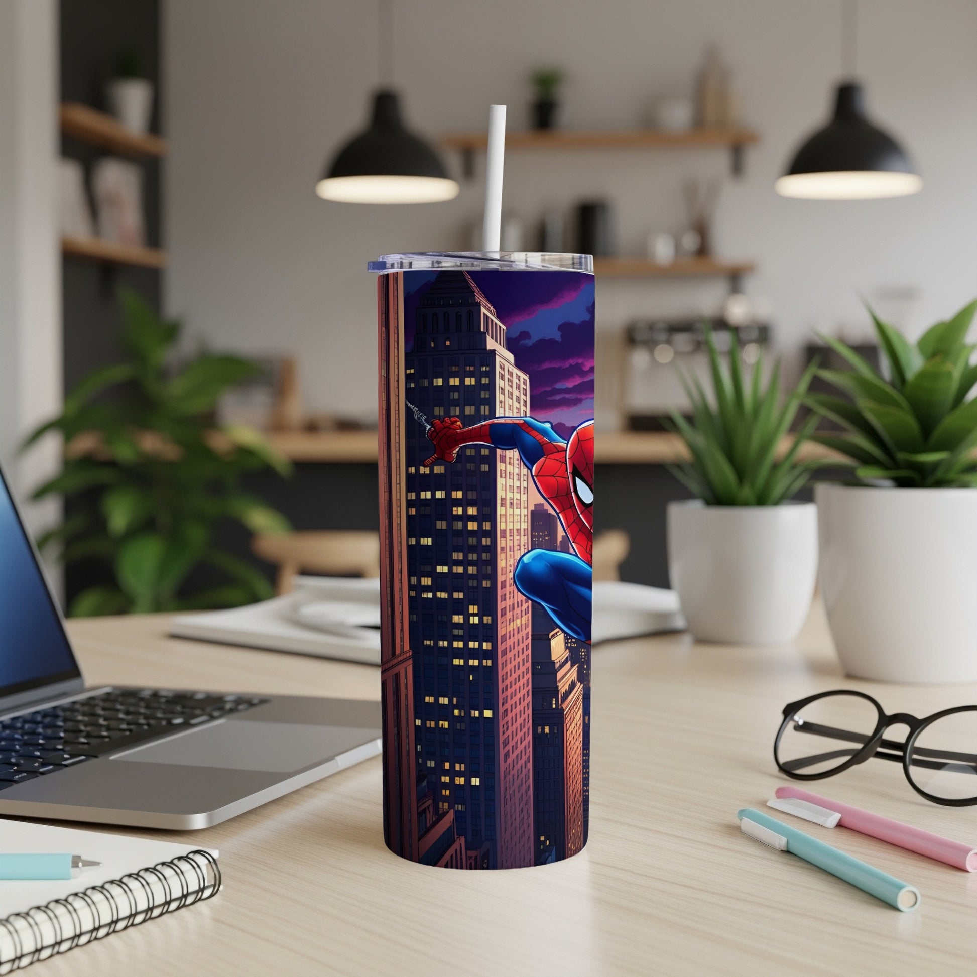 Spiderman climbing a building at night, tumbler on a desk.